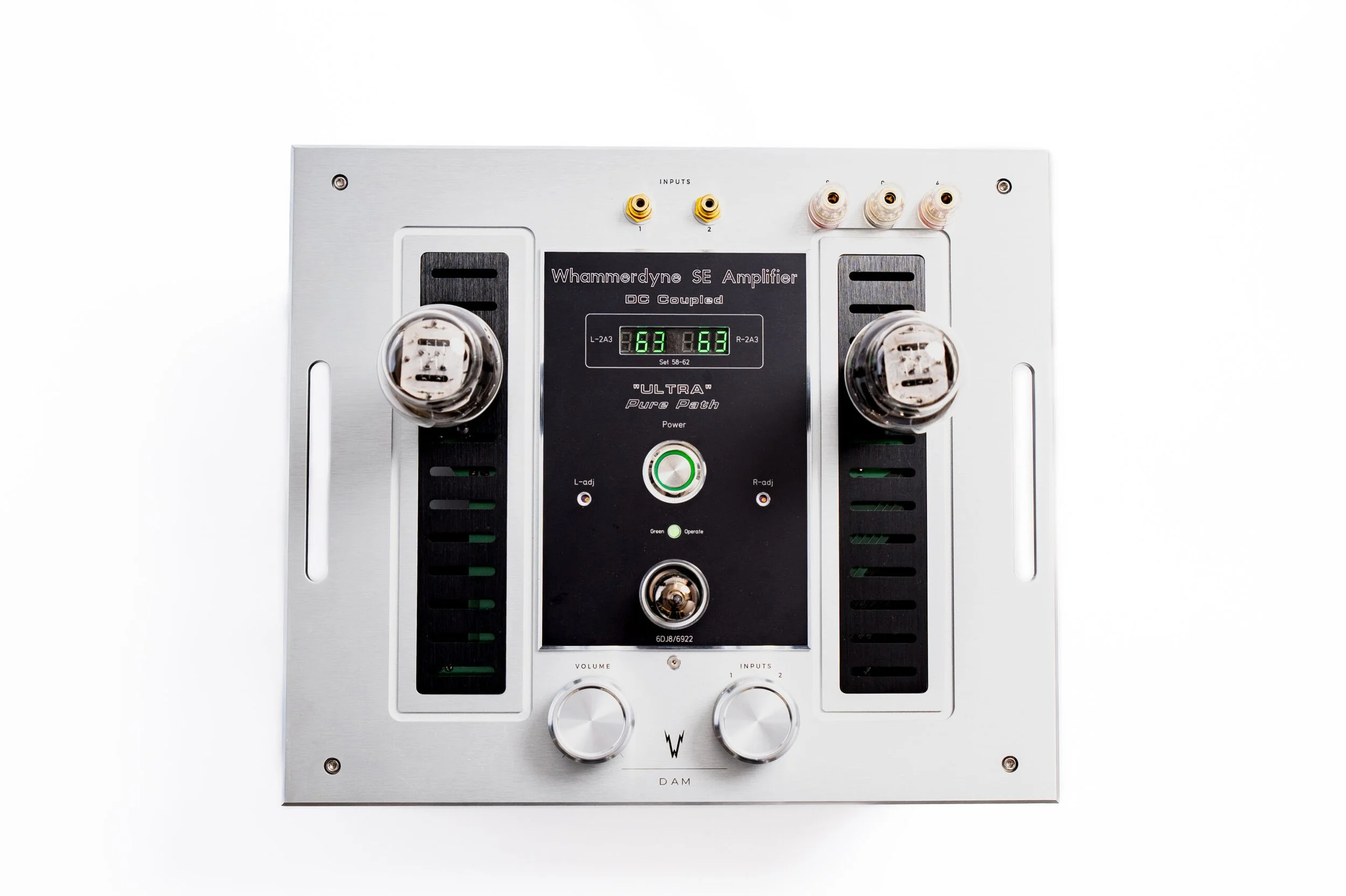 Whammerdyne Damn Awesome Mono mono amplifier shown from above, featuring brushed aluminum top plate, dual vacuum tubes, central control panel with green bias display, and volume and input selector knobs.