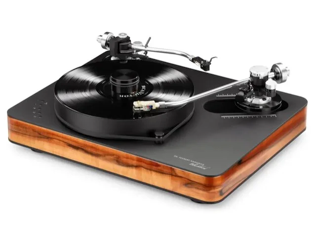 Dr. Feickert Analogue Blackbird turntable in Tineo wood finish, three-quarter view with record playing, showing high-mass platter, dual tonearm mounts, and precision belt-drive motor assembly.