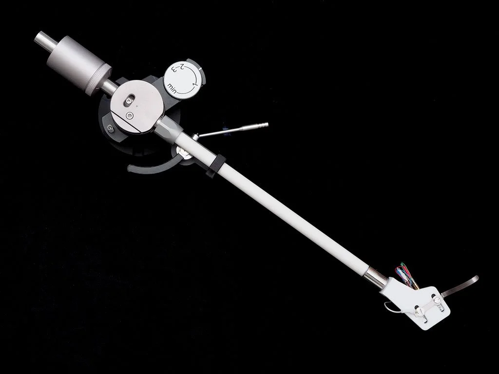 Korf TA-AF9/10 tonearm with white ceramic arm tube, flexure bearing assembly, and detachable headshell shown in three-quarter view against a black background.