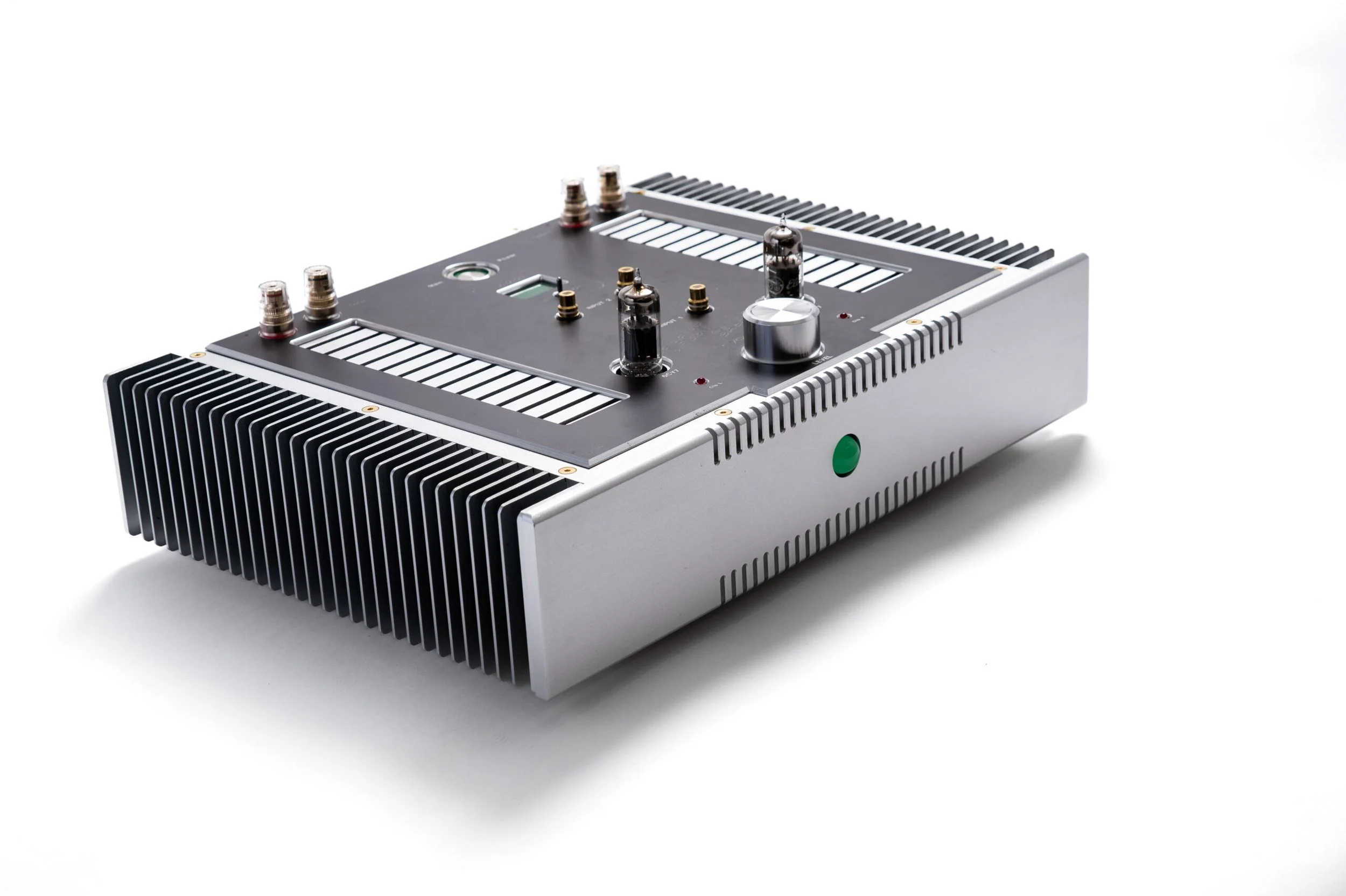 Whammerdyne Circuit Salad amplifier shown from a front three-quarter angle, featuring a brushed aluminum chassis, large side heat sinks, dual small-signal tubes, central volume control, and minimalist top-plate layout.