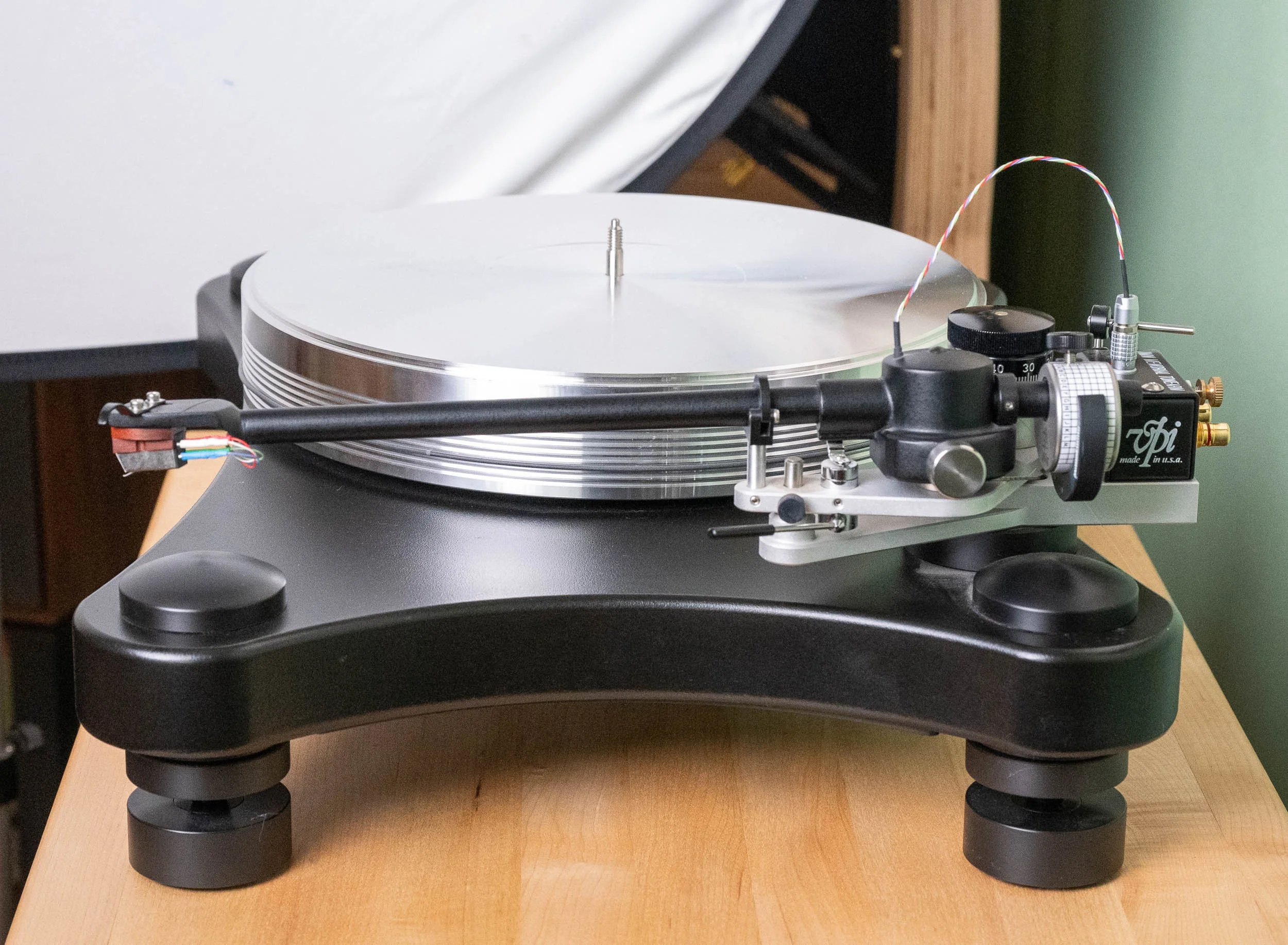 Side view of the VPI Prime turntable highlighting its 3D-printed tonearm, adjustable counterweight, aluminum platter, and isolation feet.