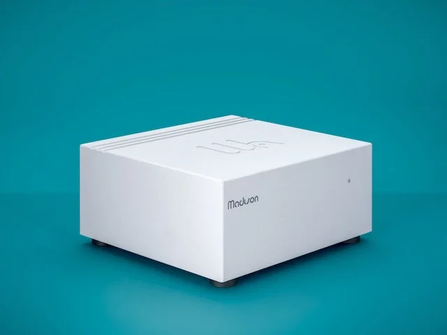 Wattson Madison Power S external power supply designed for Wattson source components, shown in light gray, teal background, 3/4 view.