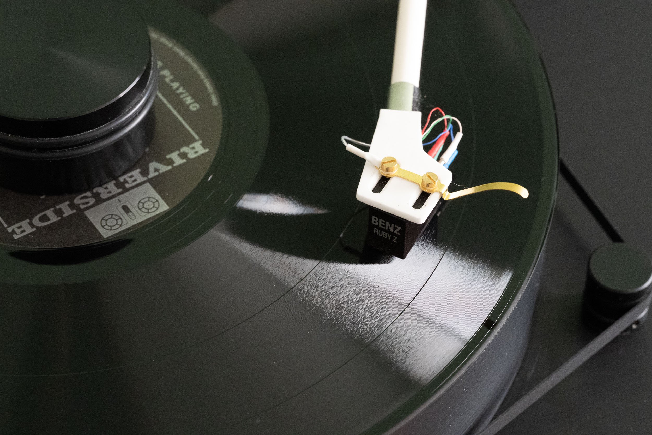 Detail of Waltz for Debby playing on the Dr. Feickert Blackbird. The black record surface is seen in contrast to the white ceramic headhell of the Korf tonearm.