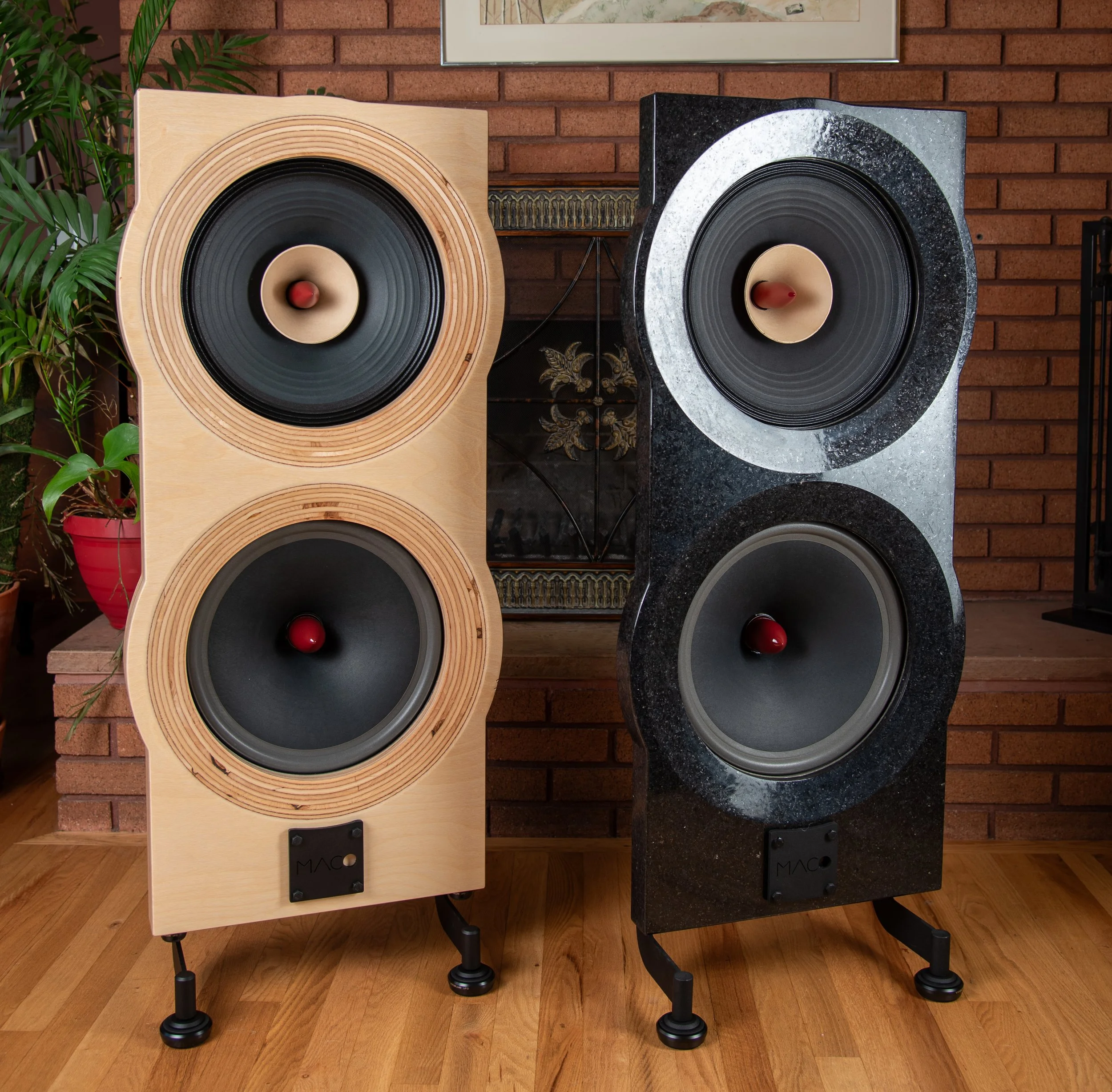 Two Maco Macarias speakers side by side, one Baltic birch and one polished granite