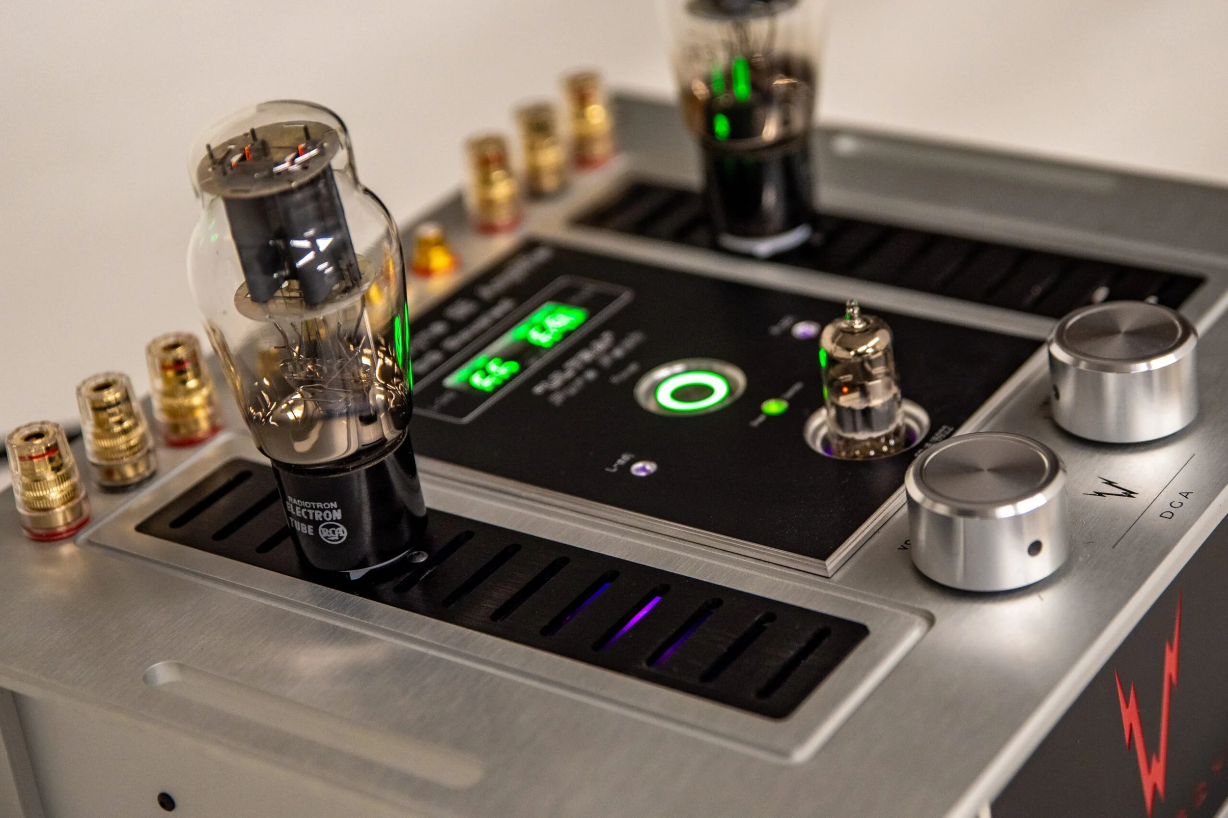 Whammerdyne DGA stereo amplifier in close-up, showing brushed aluminum chassis, 2A3 output tube, illuminated bias display, volume and input controls with signature red “W” logo on the front panel.