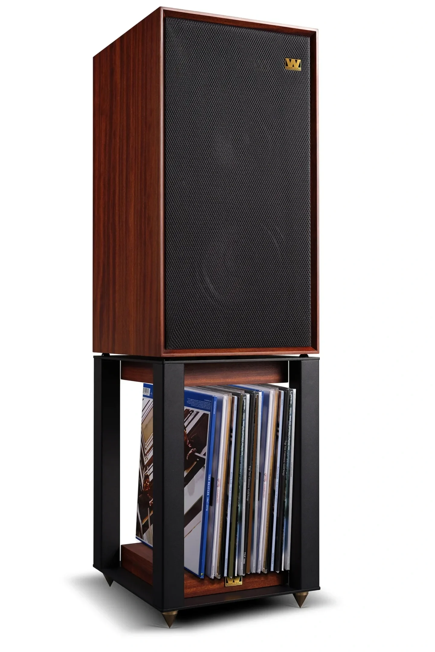 Wharfedale Linton 85 in Mahogany finish with the grille installed on its matching stand, with vinyl records stored on the stand’s lower shelf.