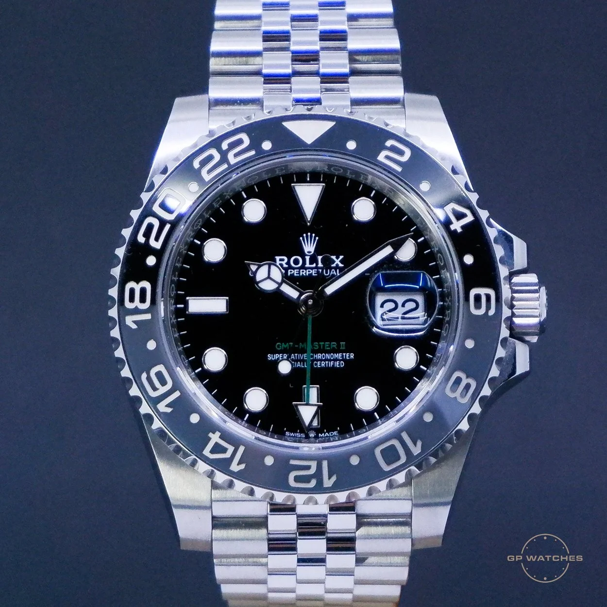 Close-up of a Rolex GMT-Master II wristwatch with a black face, silver bezel, and metal bracelet, displaying the date at 3 o'clock.
