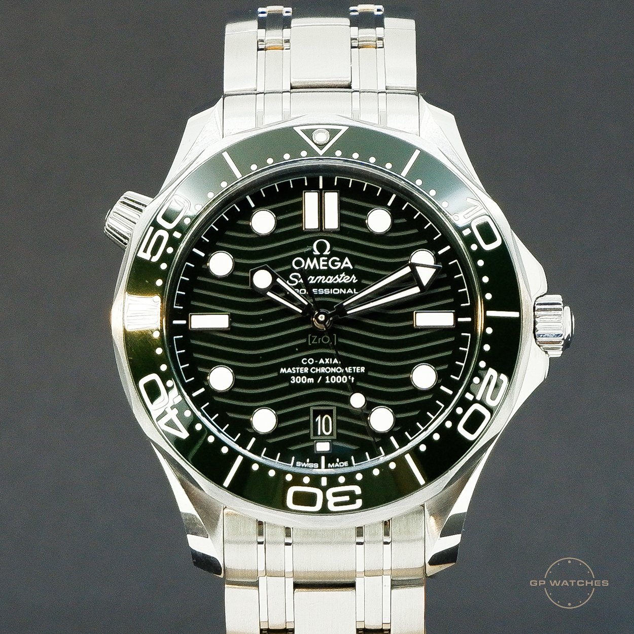 A silver omega Seamaster professional wristwatch with a black dial, white markers, and a rotating bezel, showing the time as 2:16 and 54 seconds, with a date window at 6 o'clock.