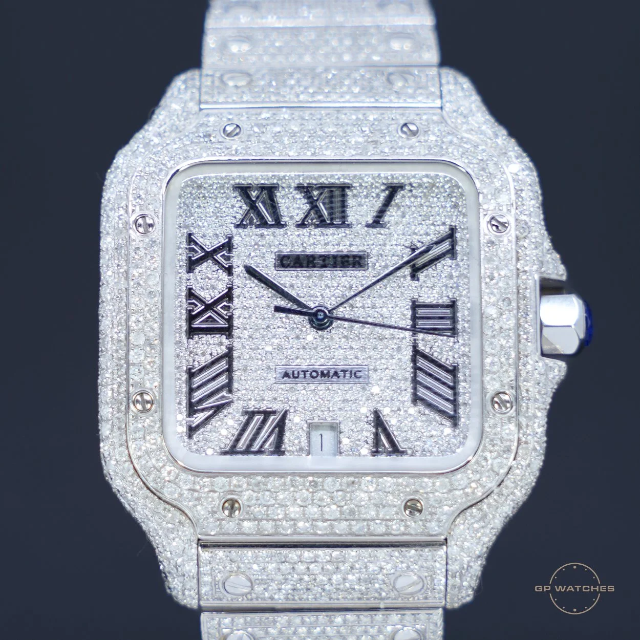 A luxury wristwatch encrusted with diamonds, featuring Roman numeral hour markers, a date window at 6 o'clock, and a diamond-studded band.