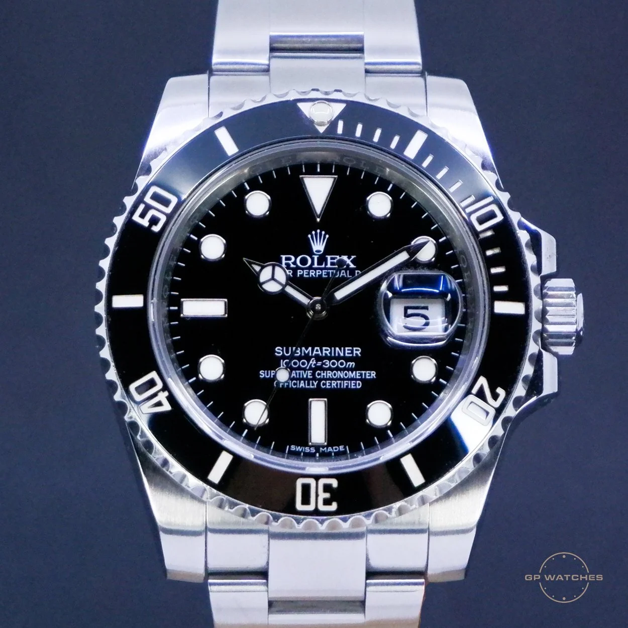 A close-up of a Rolex Submariner watch with a black dial, luminescent hour markers, and a rotating black bezel with white markings, featuring a date window at 3 o'clock.