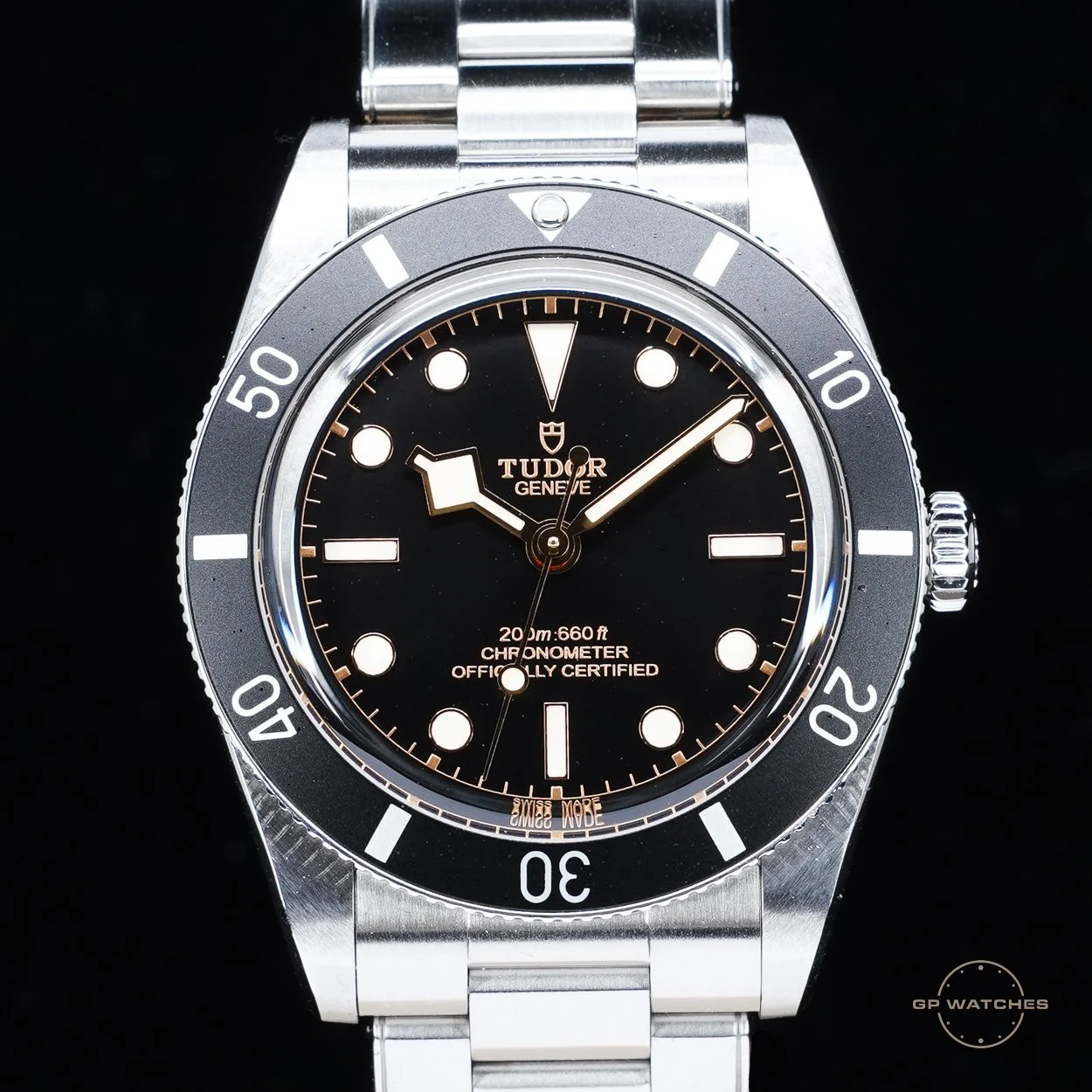 Tudor Black Bay Fifty-Eight wristwatch with black dial, luminous markers, and stainless steel bracelet, showing the time at approximately 8:07.