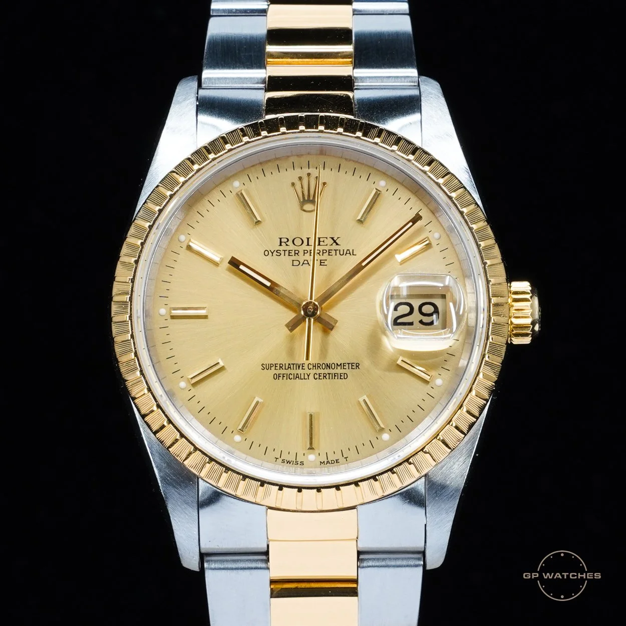 A luxury Rolex wristwatch with a gold dial, gold bezel, and a two-tone metal band, displaying the date as the 29th.