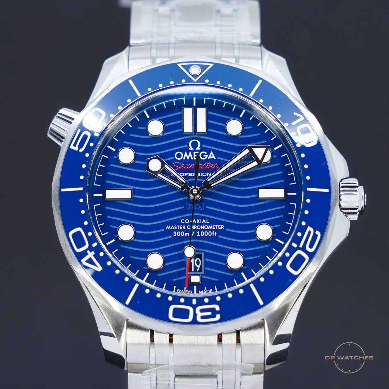 Blue Omega Seamaster professional wristwatch with a rotating bezel, date display, and a stainless steel bracelet.