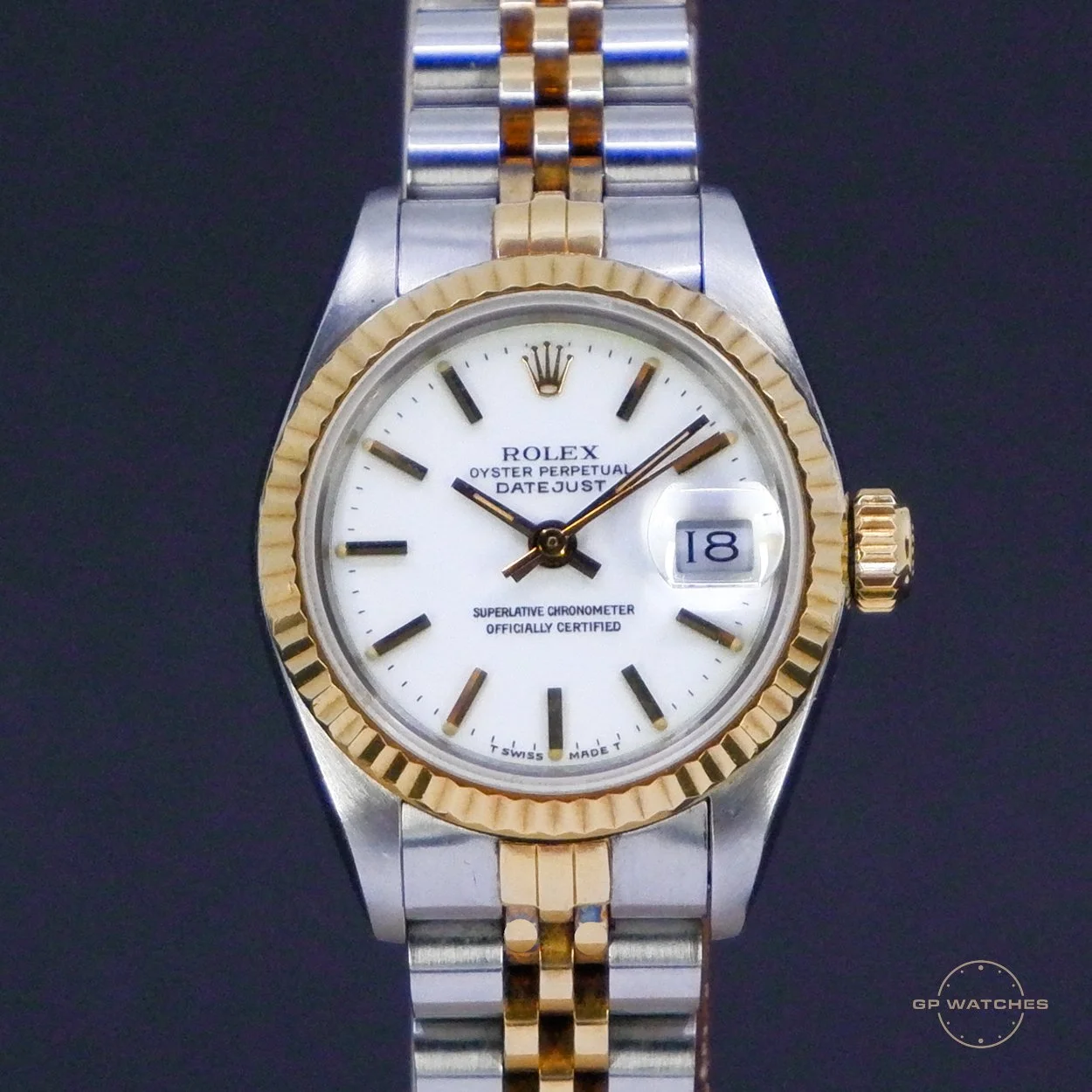 A Rolex Oyster Perpetual Datejust wristwatch with a two-tone metal band, white dial, and gold bezel. The watch displays the date at the 3 o'clock position and has a black hour hand, minute hand, and a gold second hand.