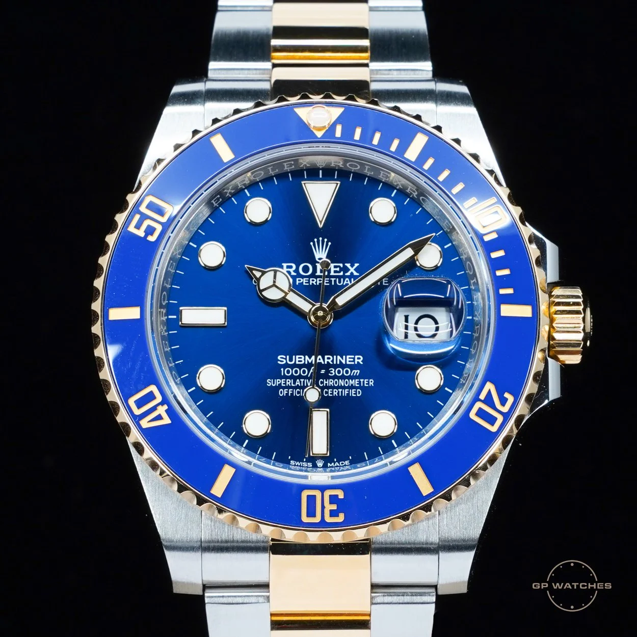 A Rolex Submariner wristwatch with a blue dial, gold and stainless steel case, and a two-tone bracelet, displaying time and date.