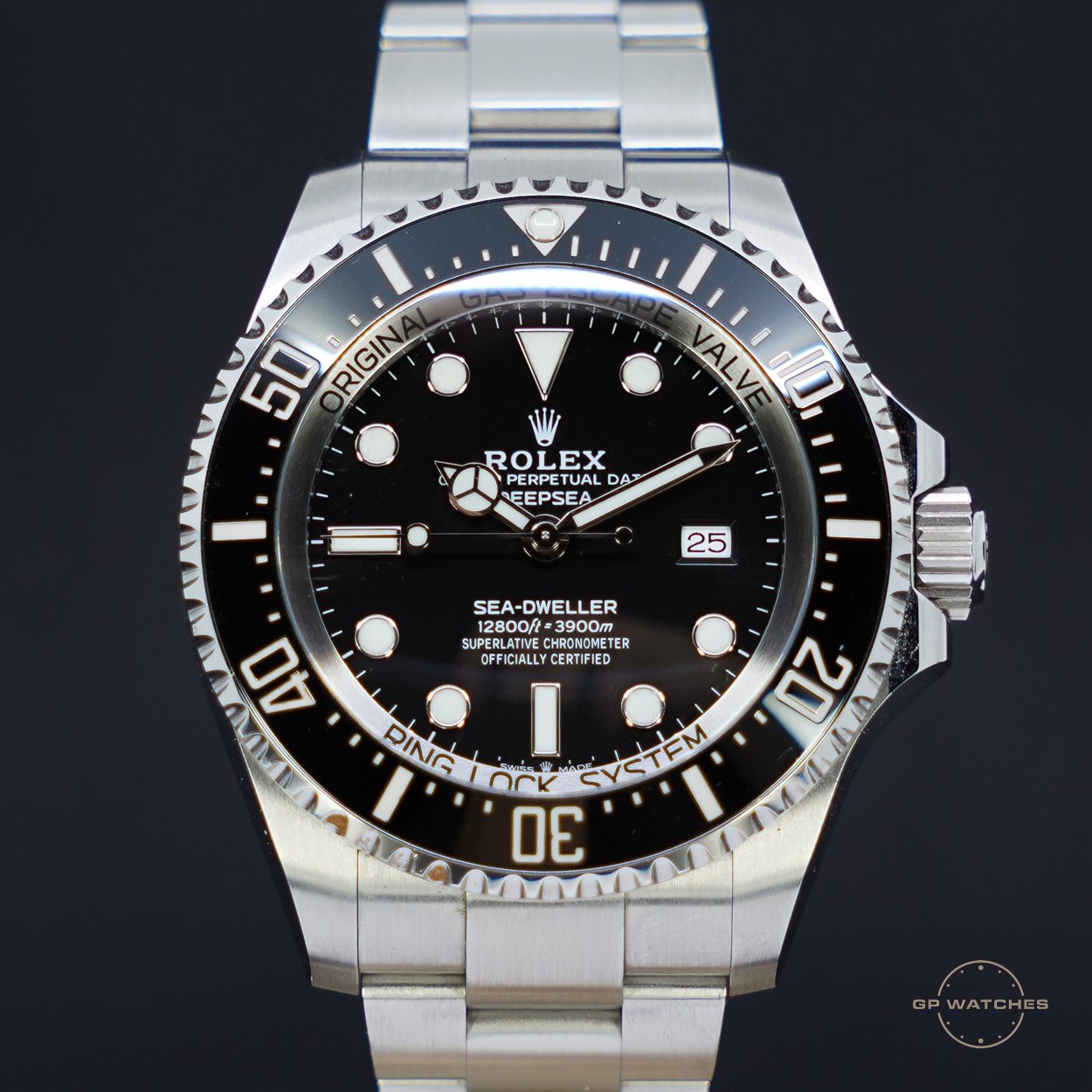 Close-up of a Rolex Sea-Dweller Deepsea watch with a black dial, silver bezel, and silver metal strap.