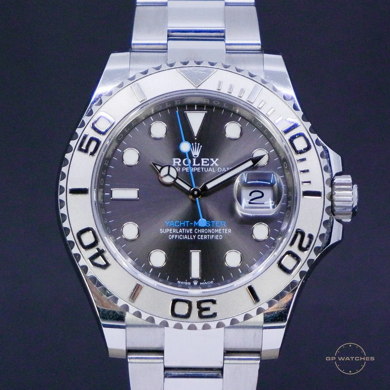 A close-up of a Rolex Yacht-Master watch with a silver and black dial, luminous markers, and a rotating bezel, displaying the time and date.