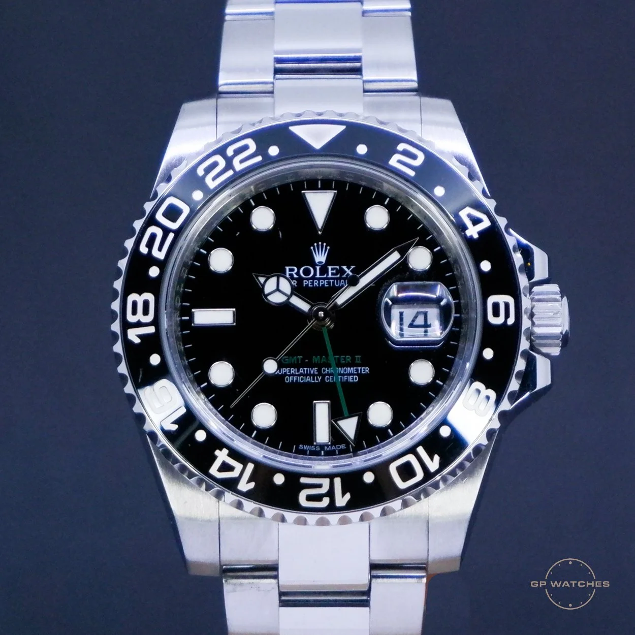 A Rolex GMT Master II watch with a black dial, silver bezel, and stainless steel band, displaying the date and time.
