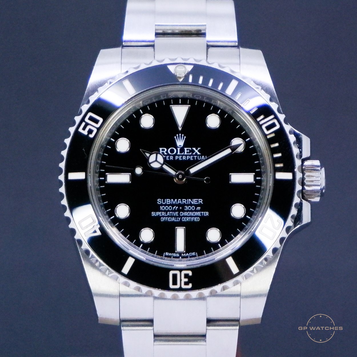 A close-up image of a Rolex Submariner wristwatch with a black dial, silver bezel, and stainless steel bracelet.