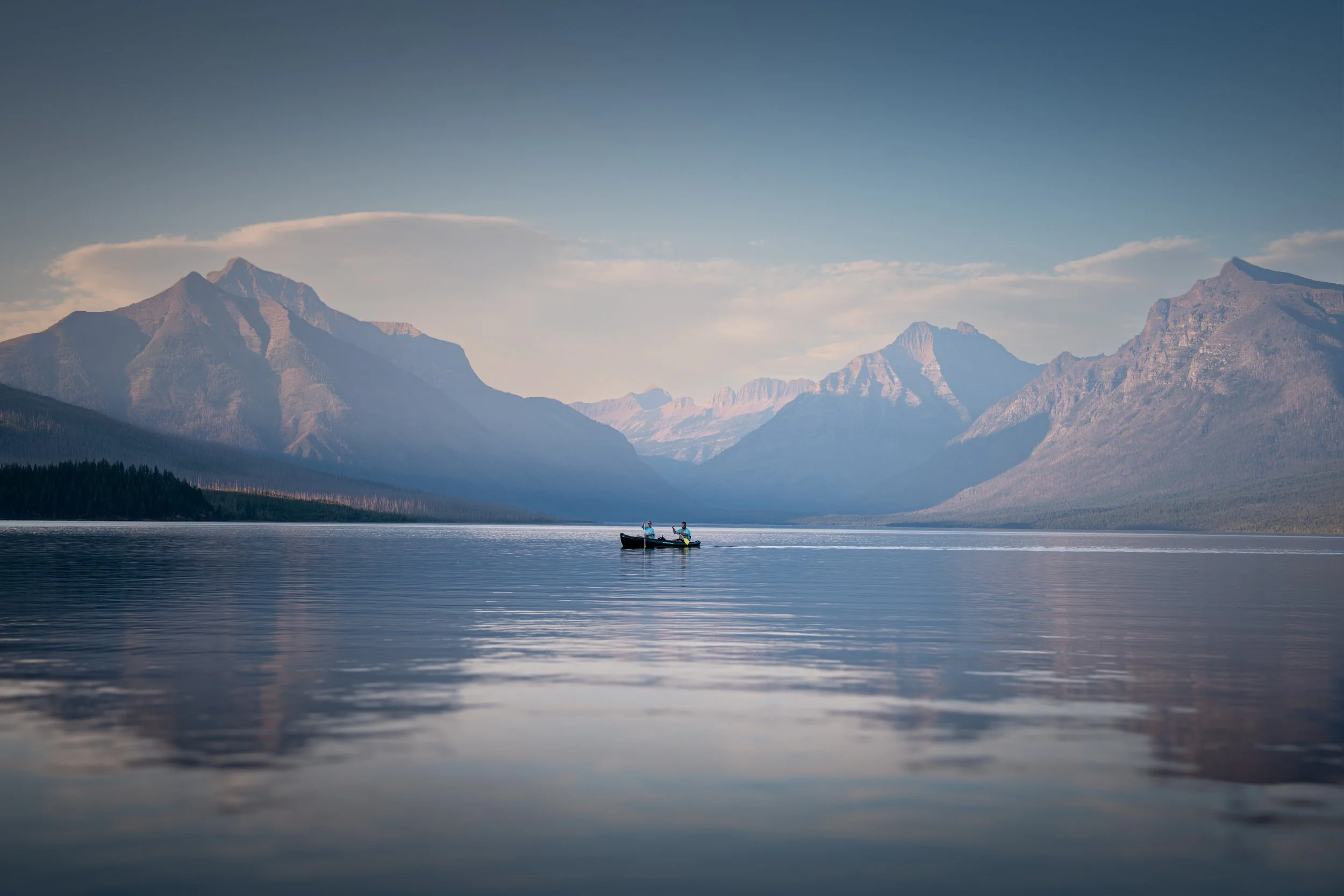 Canoe with two paddlers in Glacier National Park