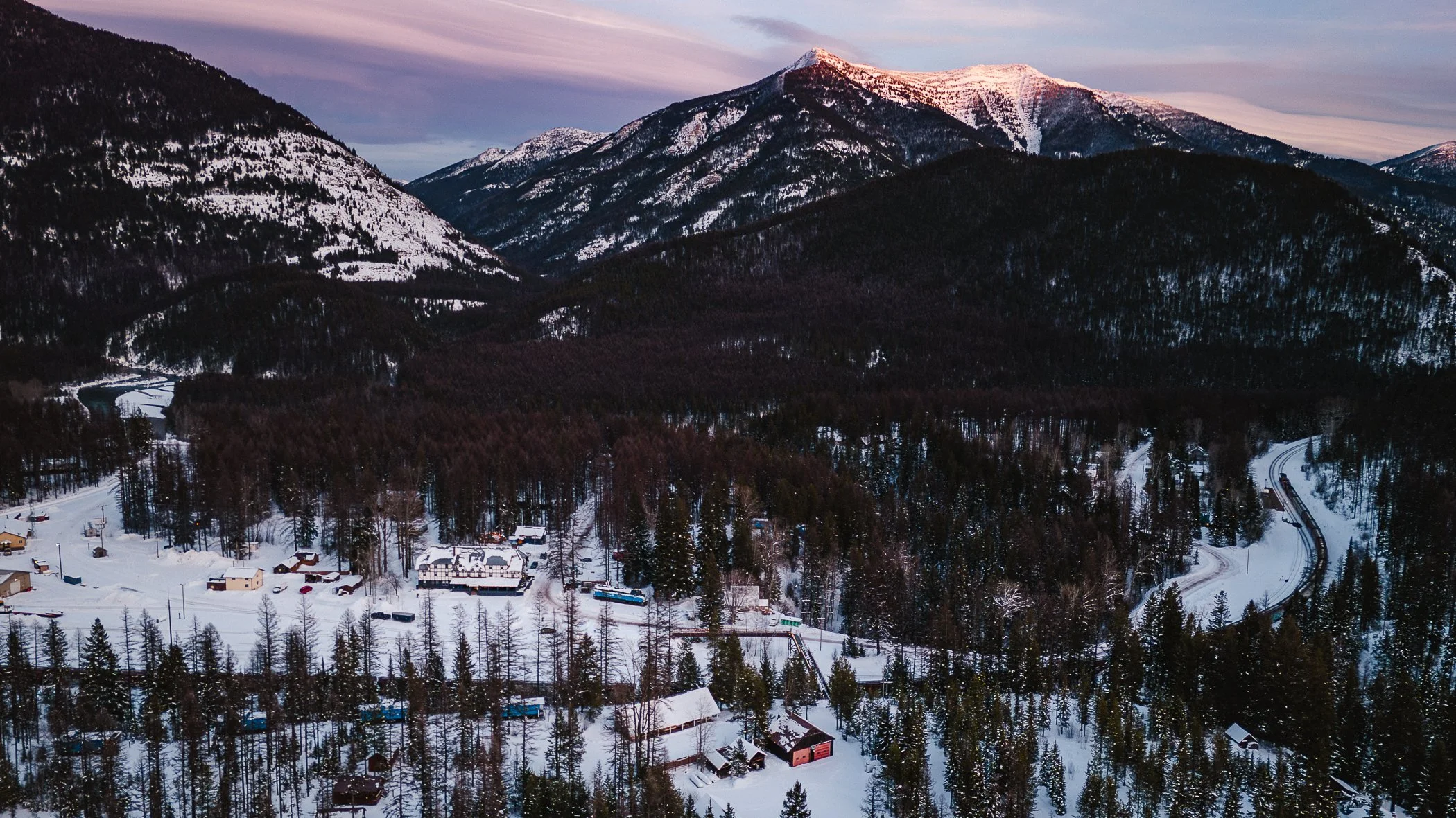 Izaak Walton Inn ski-in cabin surrounded by snow in Essex, Montana