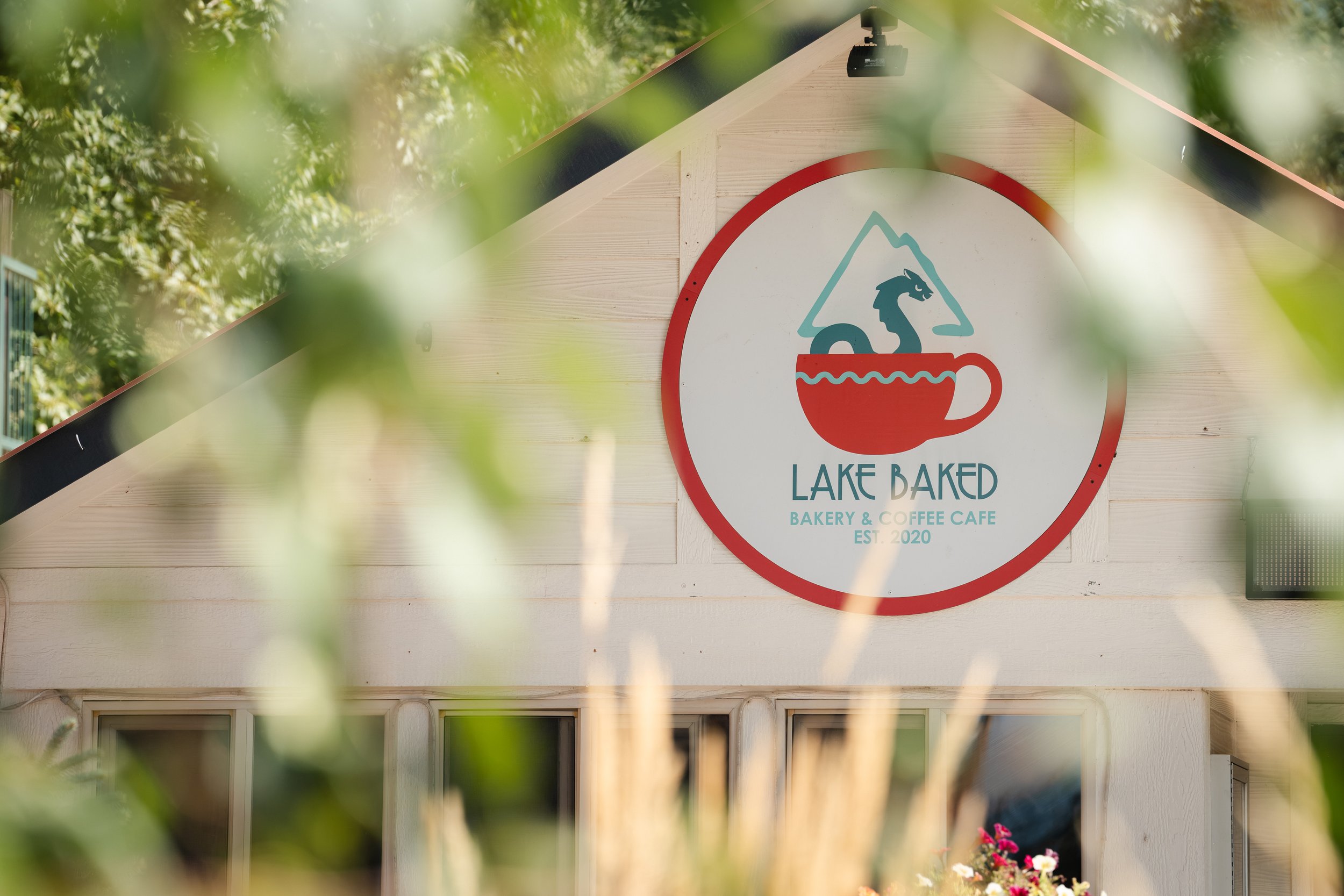 Lake Baked's sign framed through summer grasses, shot on location in Bigfork.