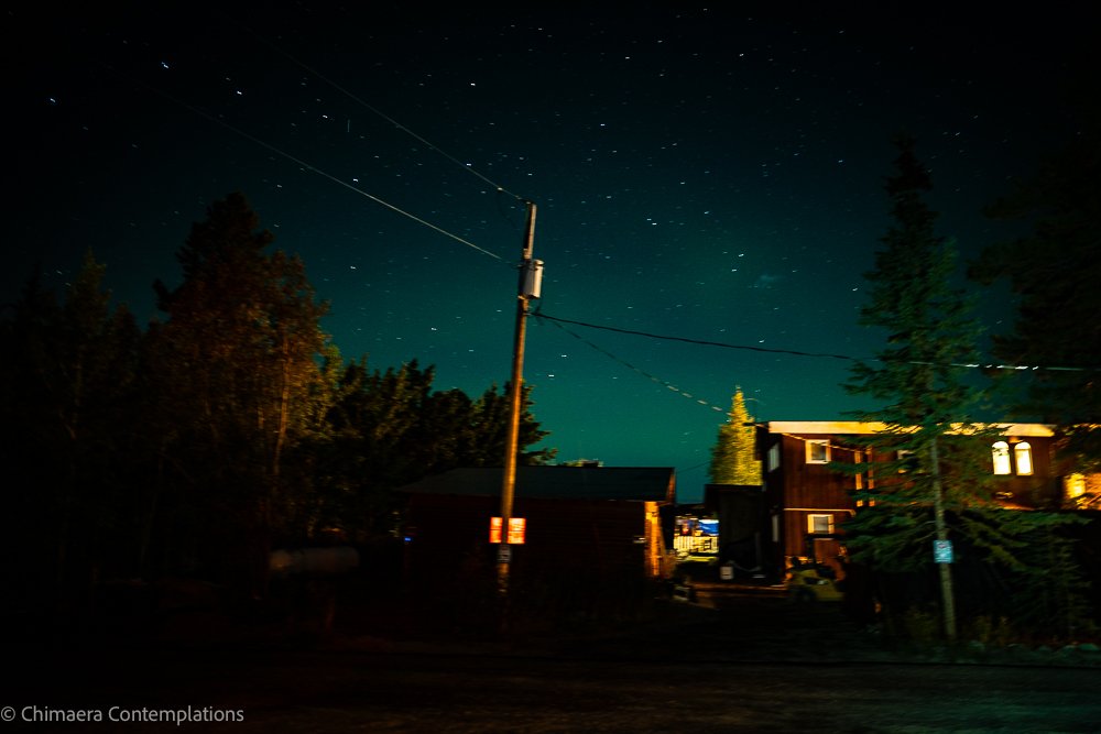 We were camping at the Caribou RV Park in Whitehorse, Yukon Territory, Canada and I woke up and thought I saw a green glow in the sky. Taken from the driver's seat with the camera propped against the window frame. I wanted to go out and take better