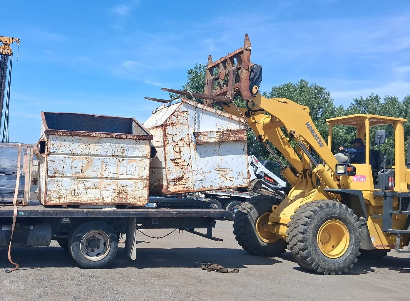 Industrial metal recycling bin being dropped off at a commercial warehouse by JVA Drop N’ Swap mobile services.