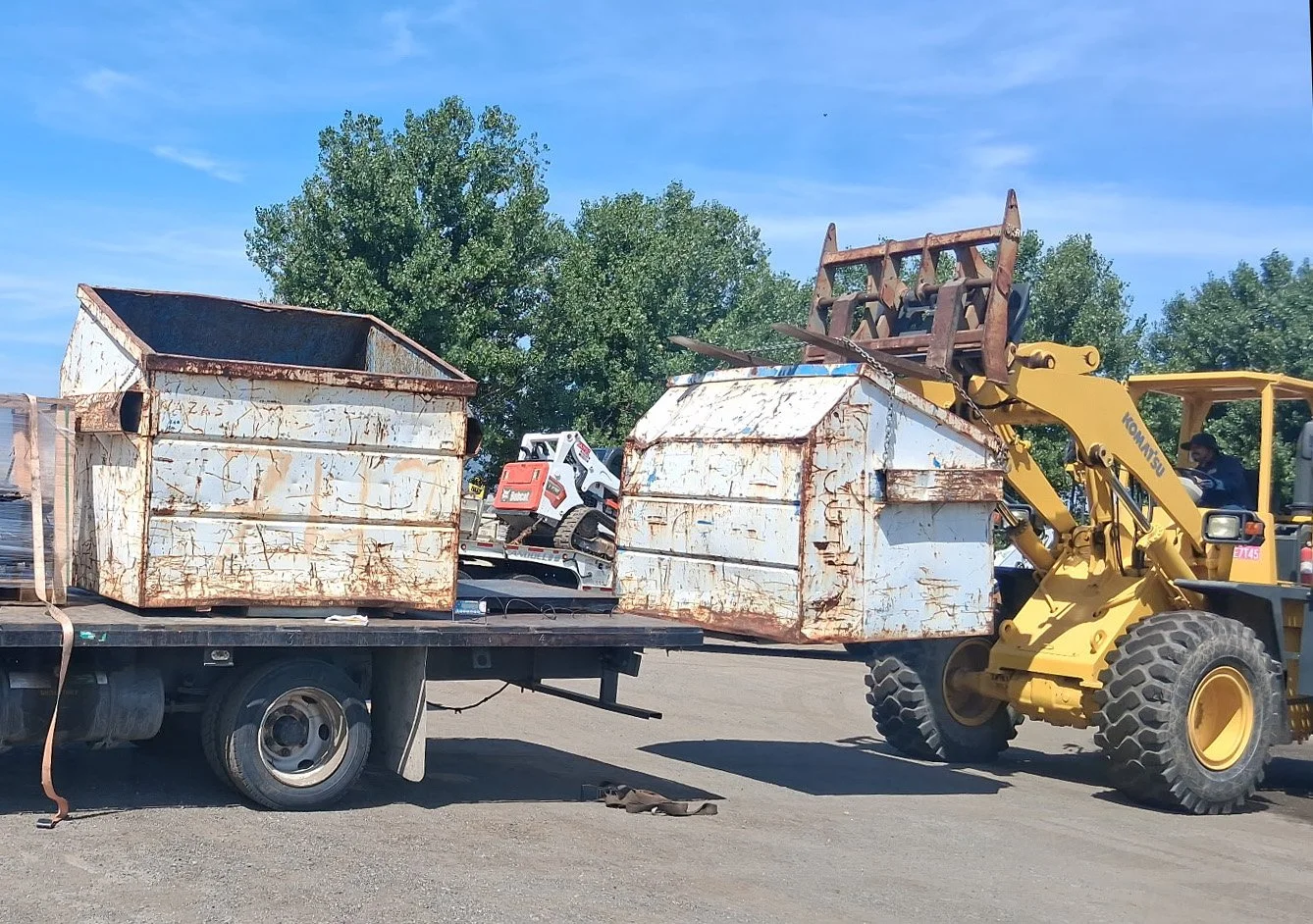 Industrial metal recycling bin being dropped off at a commercial warehouse by JVA Drop N’ Swap mobile services.