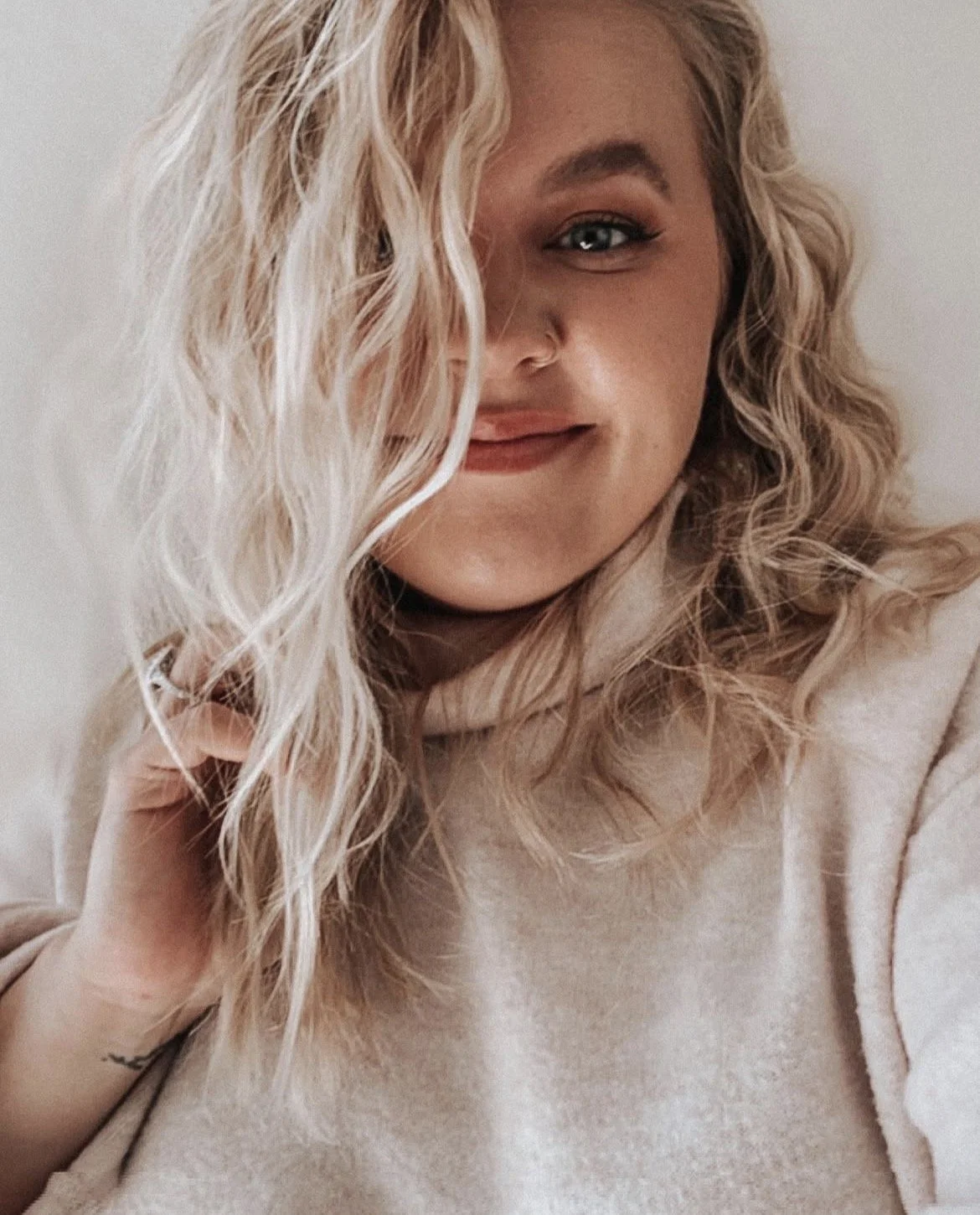 Blonde hair stylist with curly hair