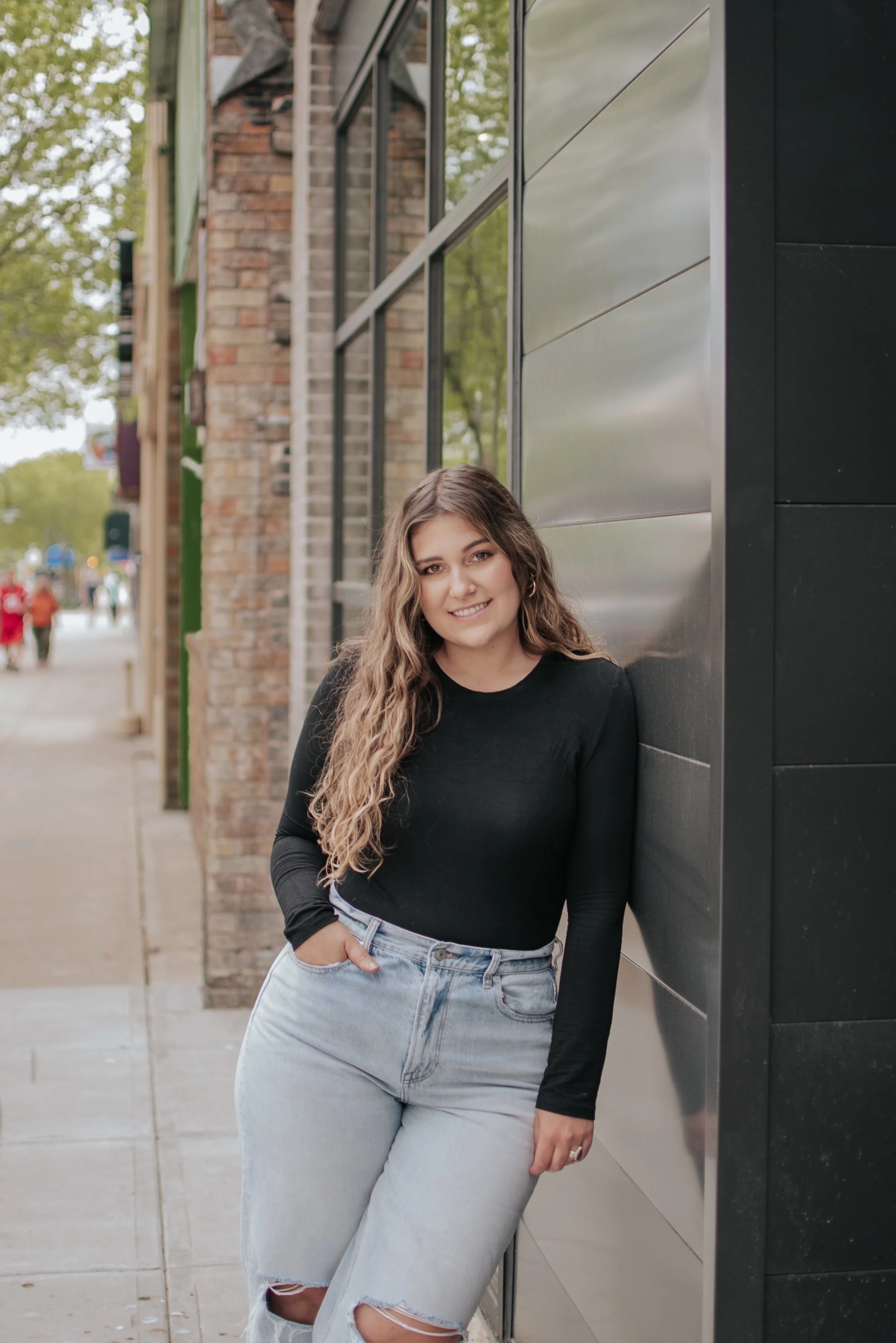 Hair stylist standing outside Coterie salon on College Ave