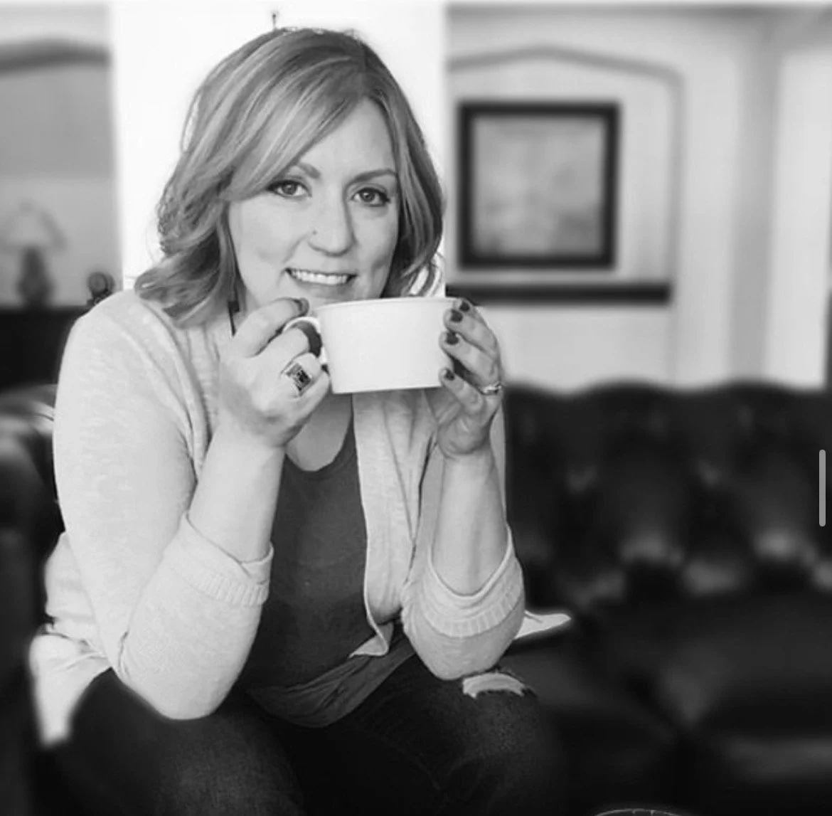 Blonde hairstylist sipping coffee