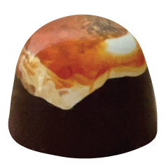 A dome-shaped dark chocolate bonbon with a glossy finish, topped with a vibrant swirl of fiery orange, white, and golden tones across the surface.