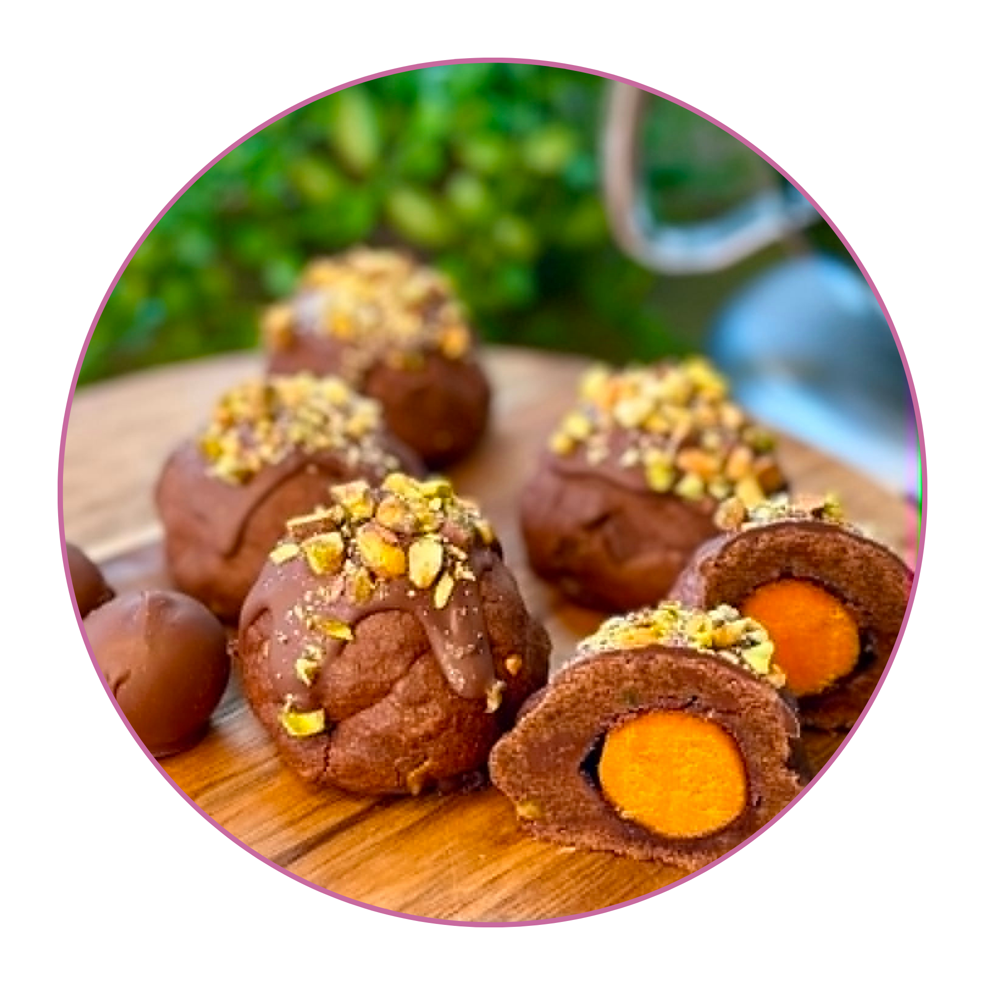 Chocolate truffles topped with chopped nuts on a wooden surface.