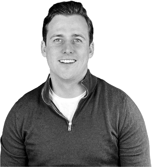 Person smiling in a blue sweater against a green background.