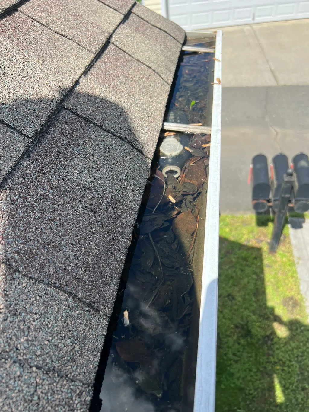 Dirty gutter with debris and water