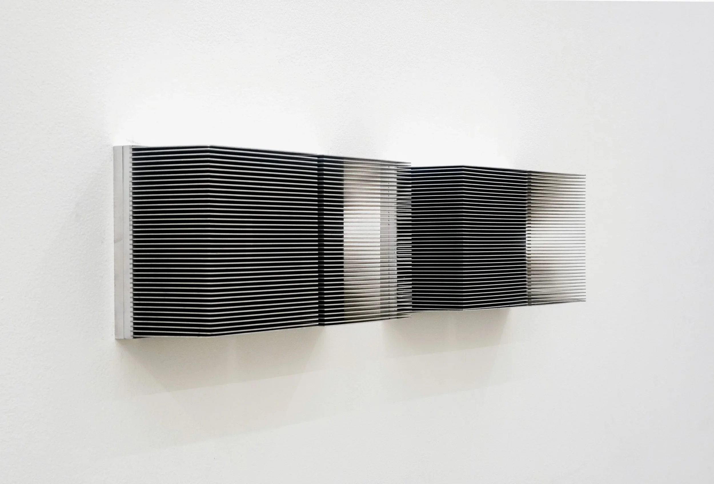 Anthony Discenza. Wall Piece, 2024. Salvaged aluminum heatsinks. Courtesy of the artist.