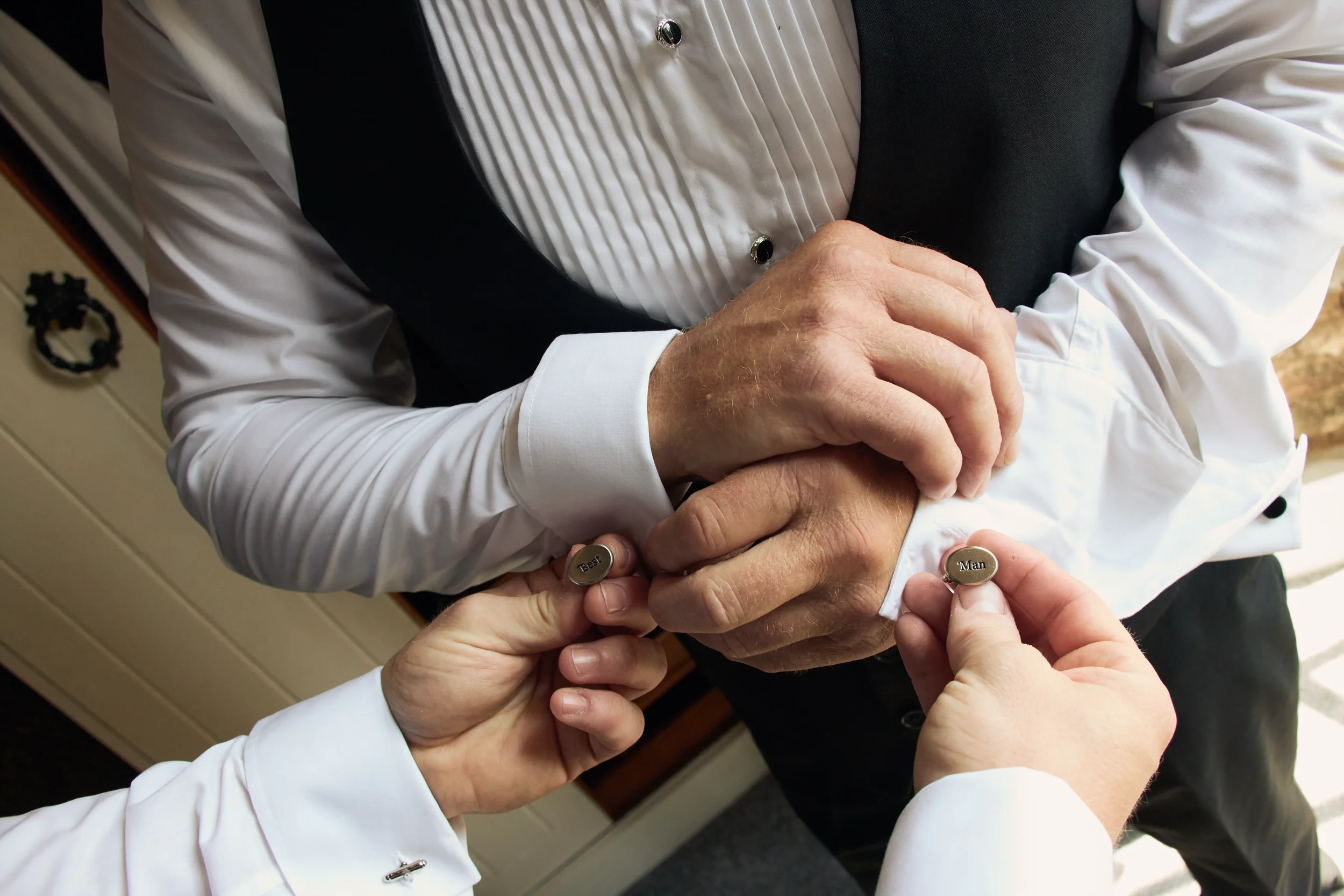 groom-helping-best-man-father-get-ready-talhenbont-hall-wedding.webp