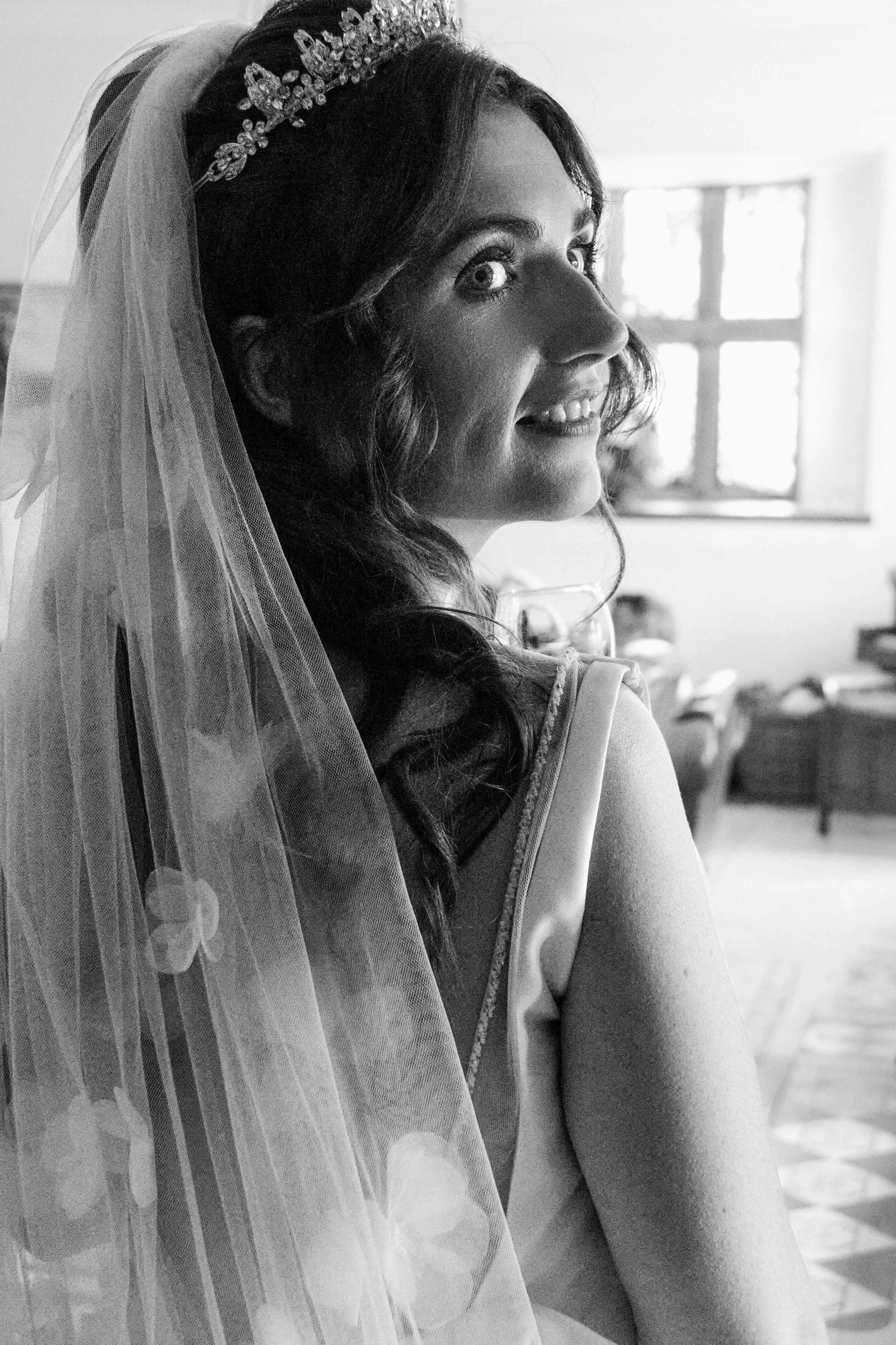 bride-looks-over-shoulder-talhenbont-hall-wedding.webp