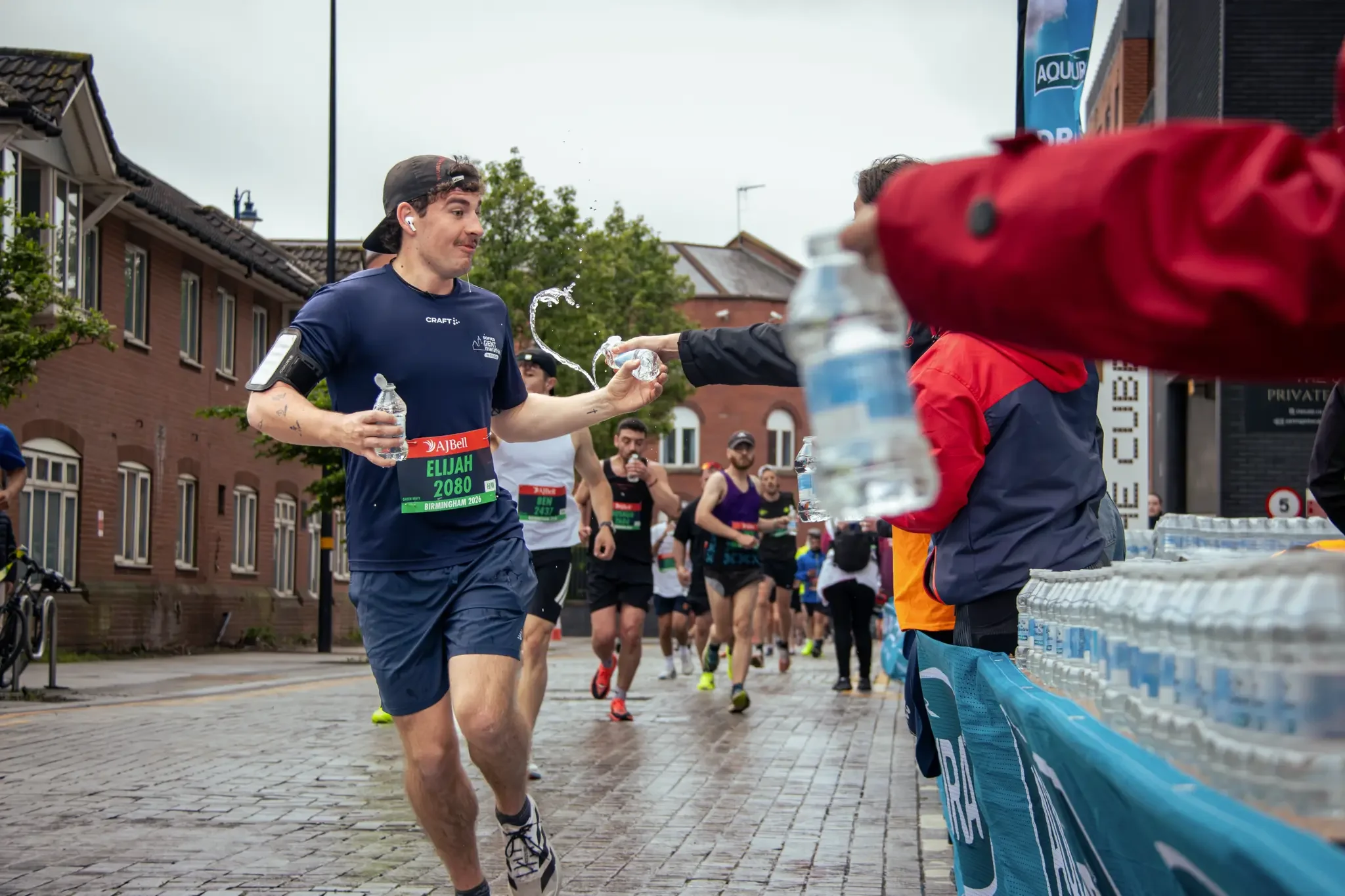 half-marathon-runner-taking-water-great-birmingham-run-birmingham.webp
