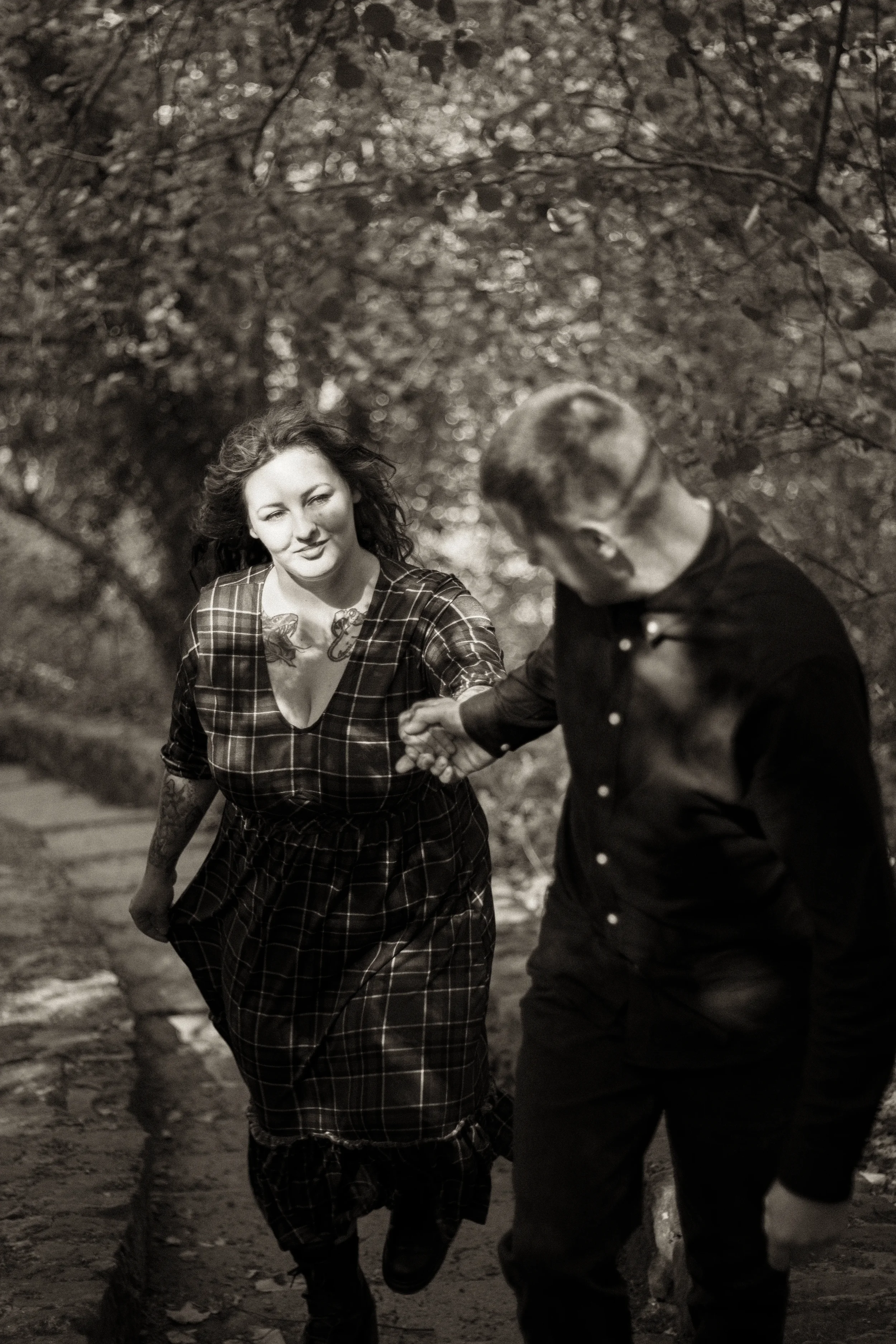 black-and-white-alternative-romantasy-couple-walking-up-steps-in-woods-ewloe-castle-ewloe-north-wales-1.webp