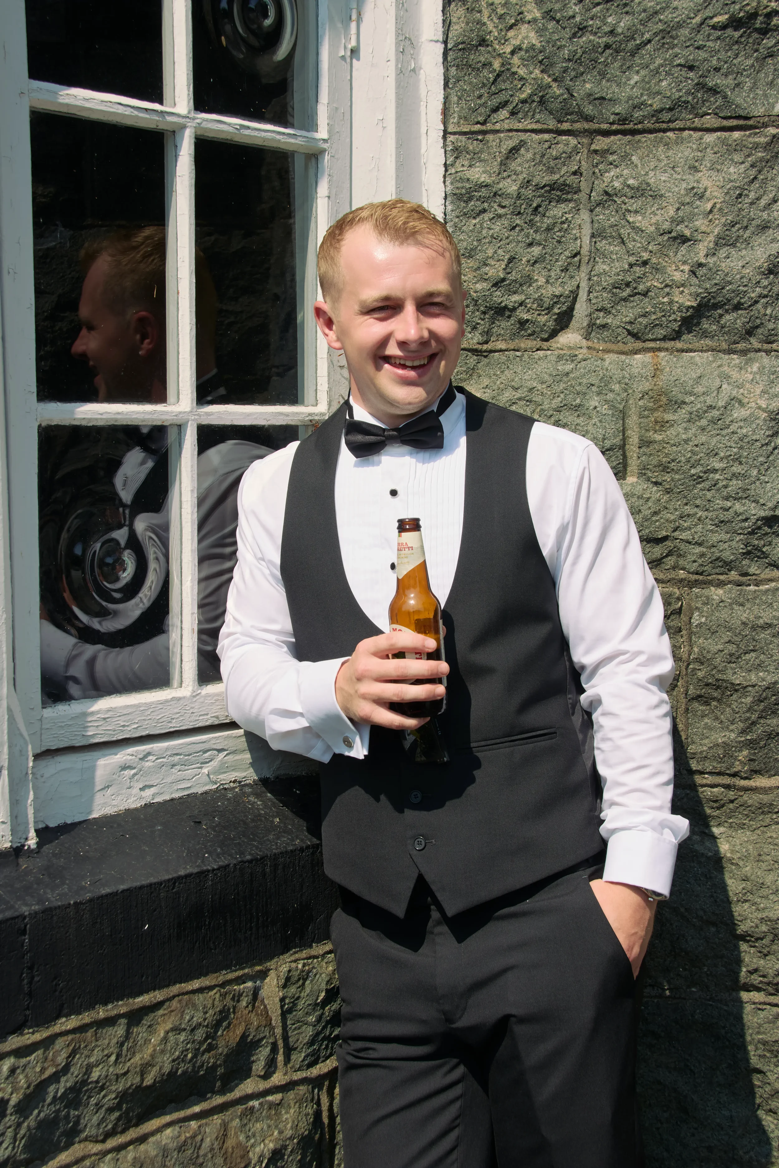 groom-casual-portrait-with-beer-talhenbont-hall-wedding.webp