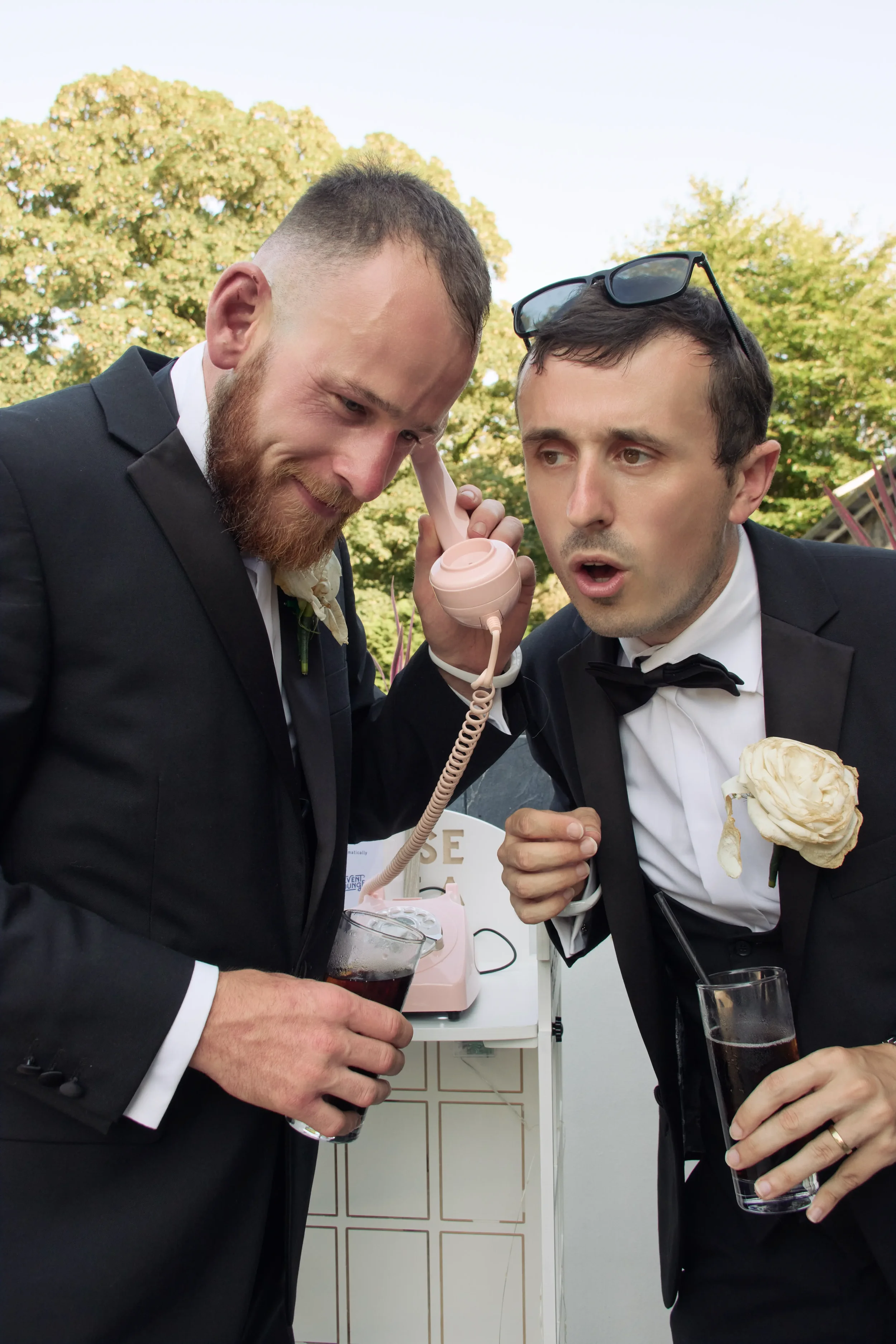 groomsmen-leaving-voice-message-on-phone-talhenbont-hall-wedding.webp