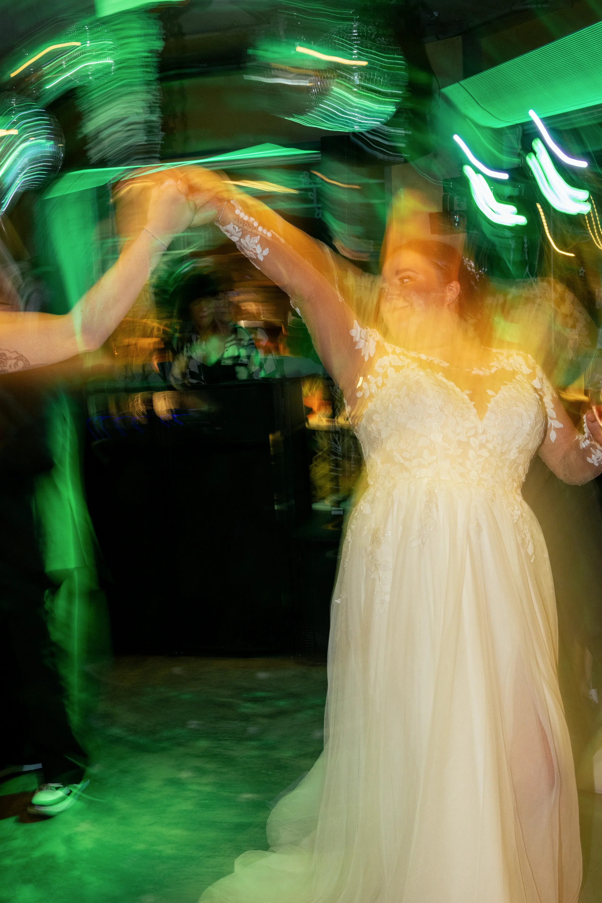 bride dancing at her wedding reception with motion blur.webp