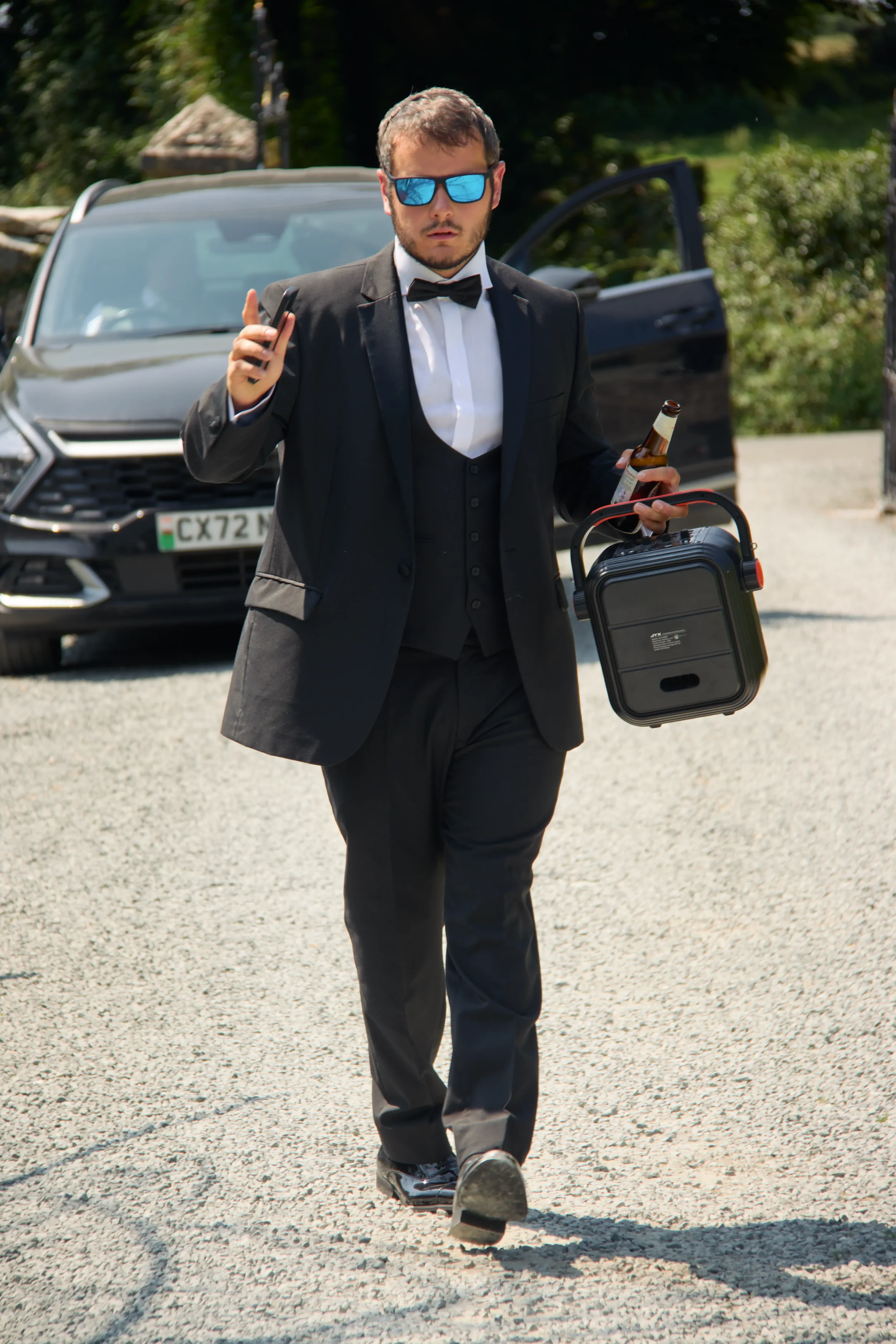 groomsman-dancing-with-boombox-talhenbont-hall-wedding.webp