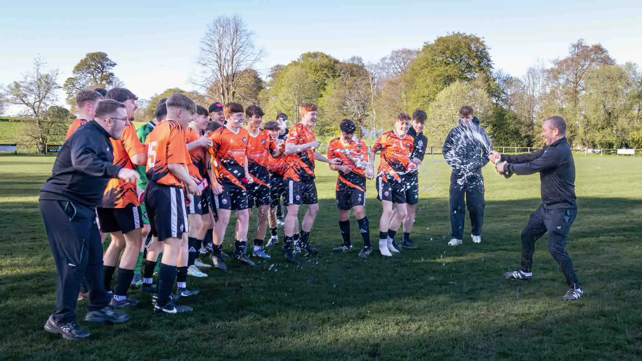 football-team-celebrating-champagne-spray-wrexham-north-wales.webp
