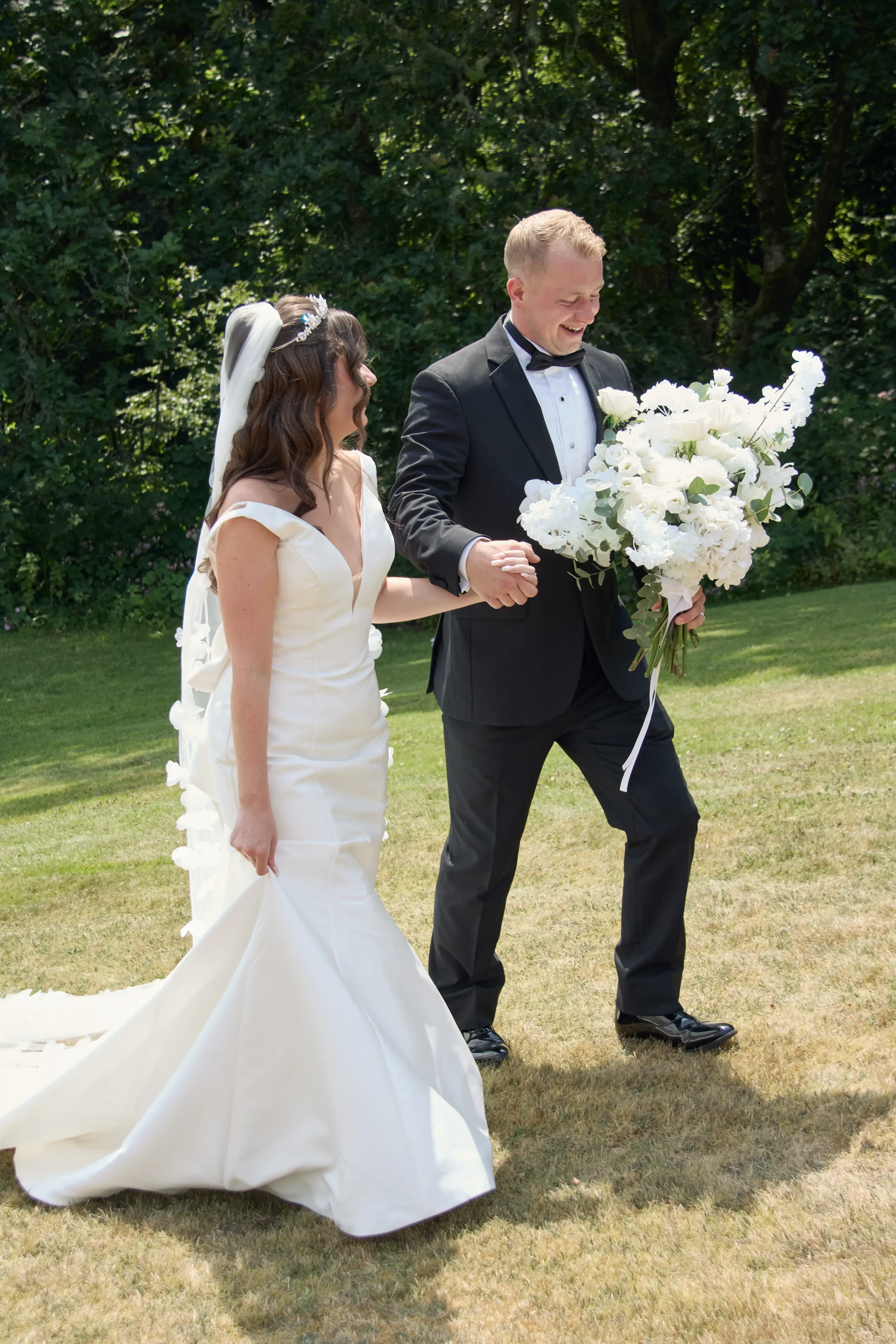 bride-and-groom-walking-away-from-ceremony-talhenbont-hall-wedding.webp