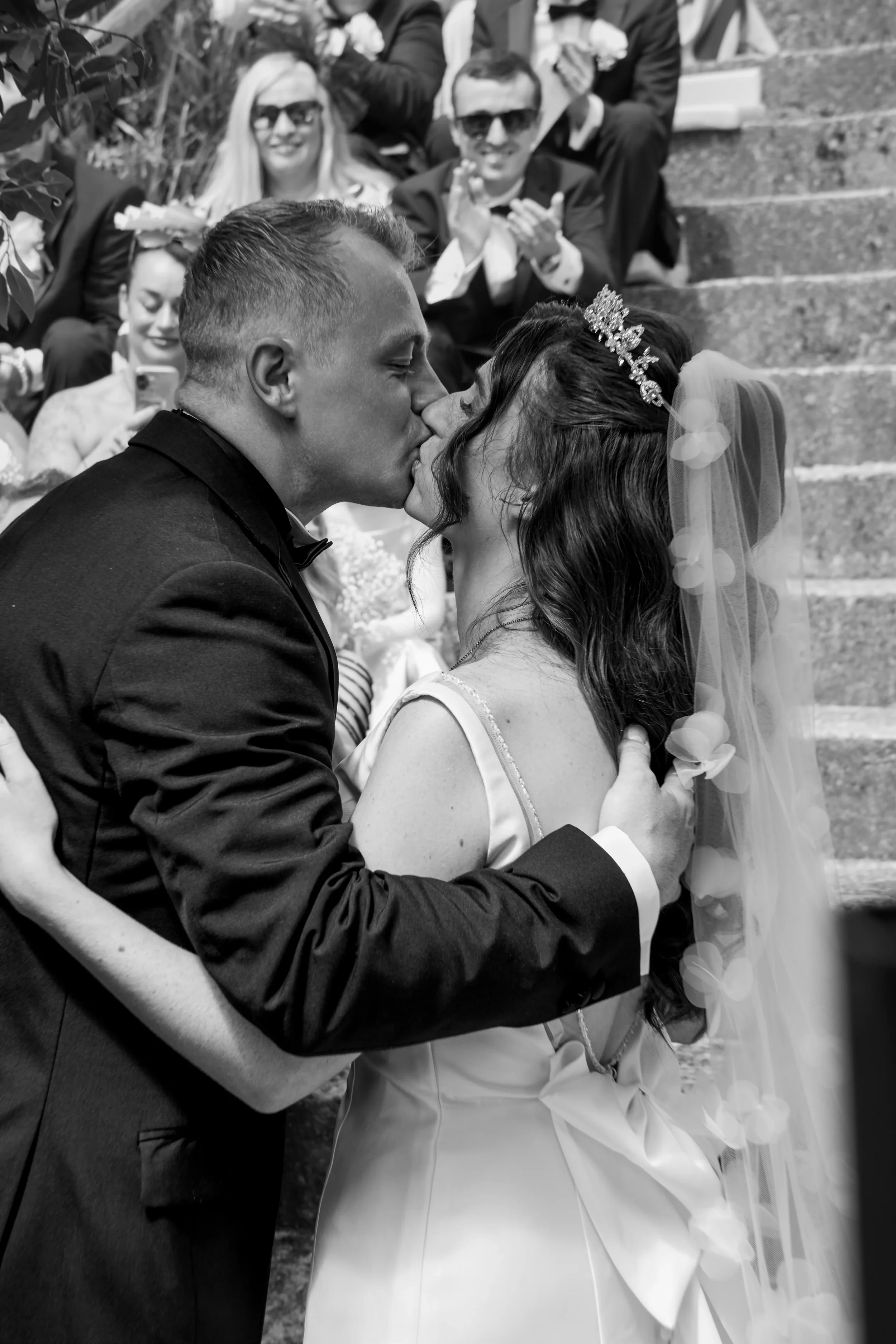 bride-and-groom-kiss-at-end-of-ceremony-talhenbont-hall-wedding.webp