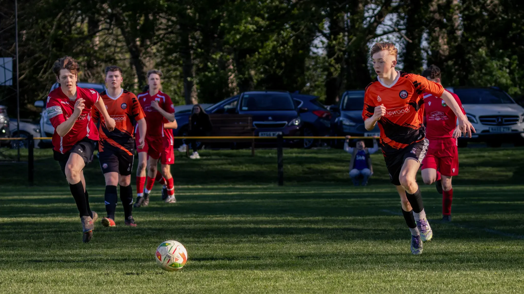 footballers-running-for-ball-wrexham-north-wales.webp