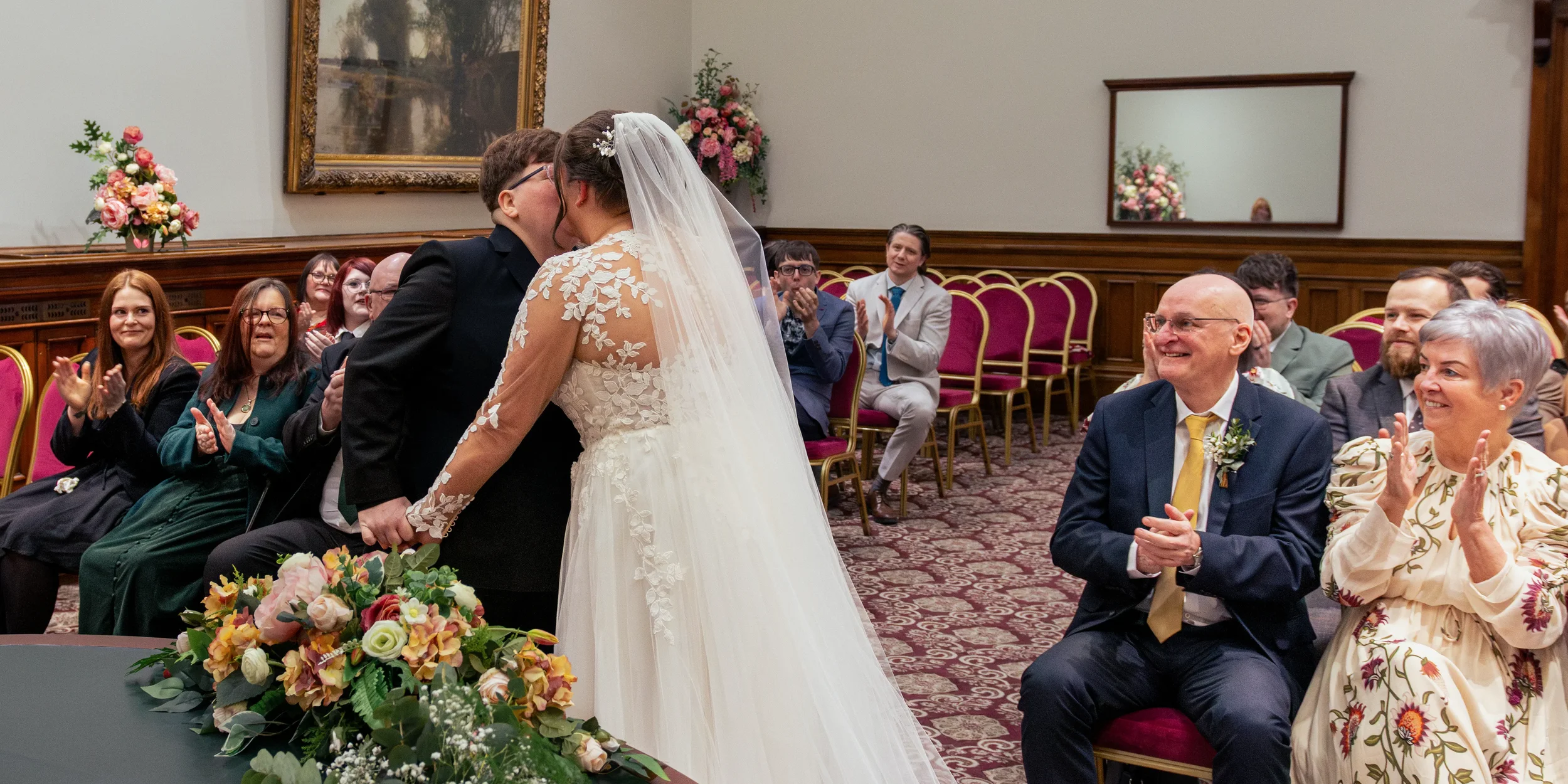 queer couple kissing at end of wedding ceremony.webp